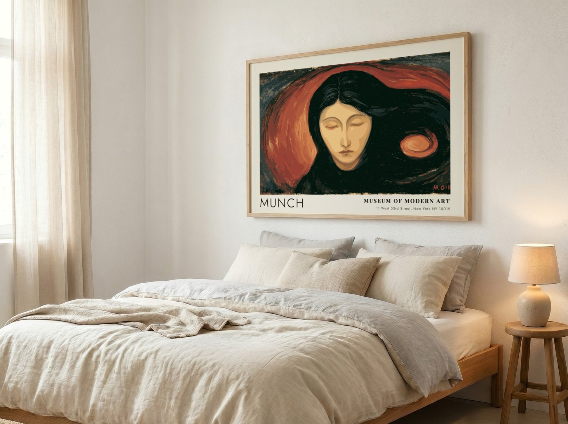 Munch Madonna exhibition poster in a light wood frame on a plain wall
