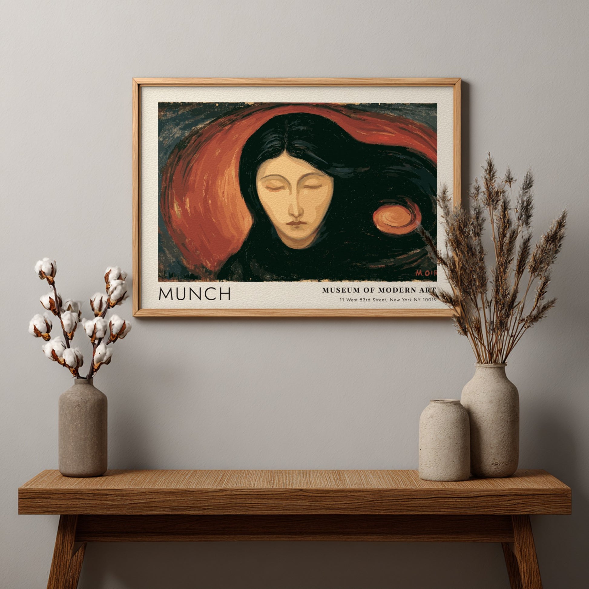 Munch Madonna exhibition poster in a light wood frame on a plain wall