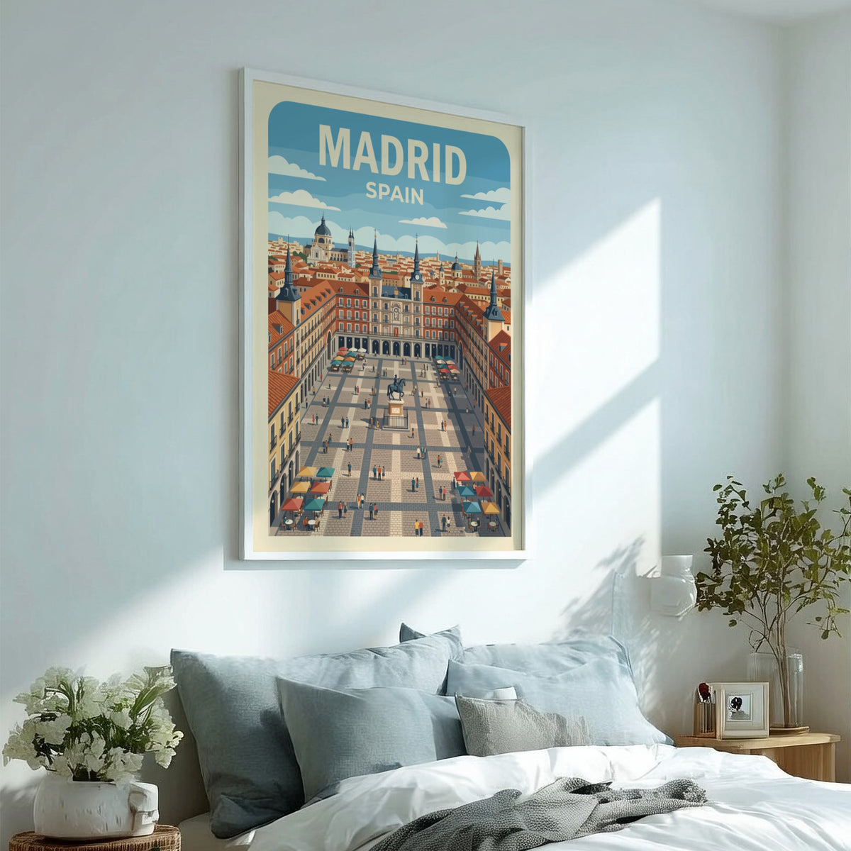 Travel poster of Madrid Spain featuring the Plaza Mayor with terracotta buildings, blue skies.