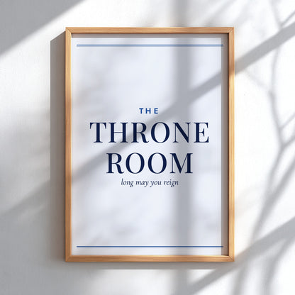 A framed typographic wall art print reading “THE THRONE ROOM” with smaller text “long may you reign,” shown hanging on a light wall with soft shadow overlays.