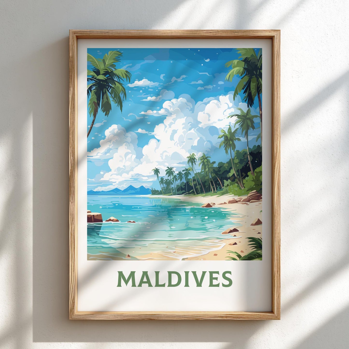 Framed artwork of a tropical beach scene with palm trees and clear blue water, labeled 'Maldives'.