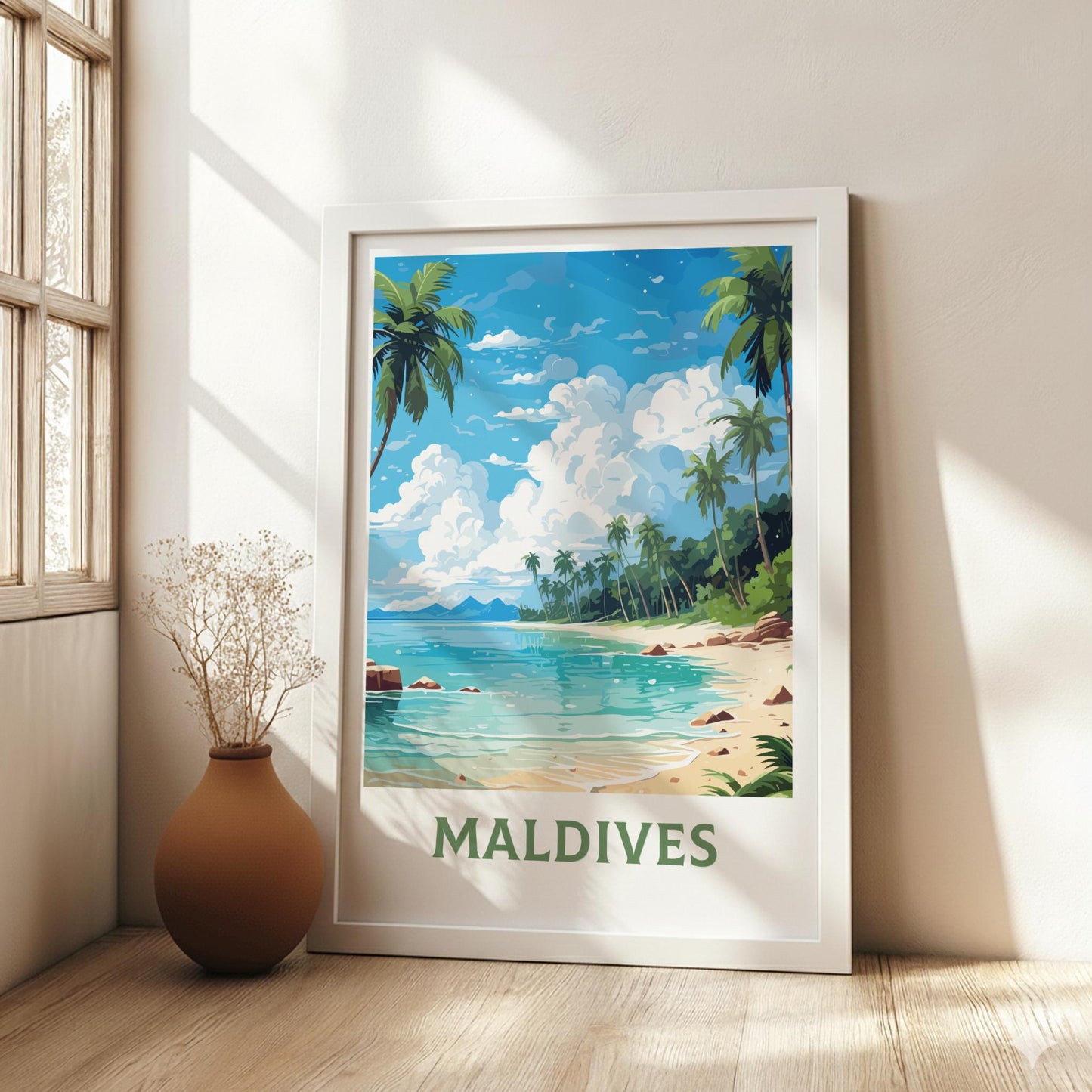 Framed artwork of the Maldives beach scene on a wall with a vase on the floor.
