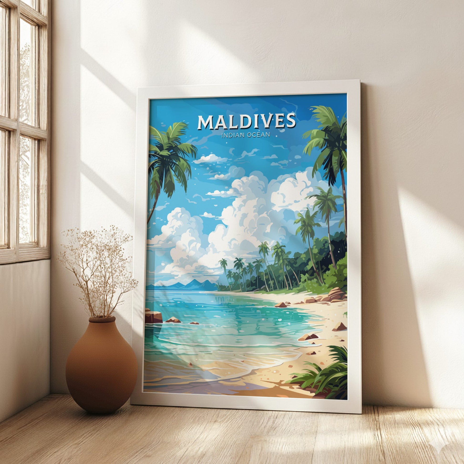 Framed artwork of the Maldives with palm trees and ocean view in a room with a vase.