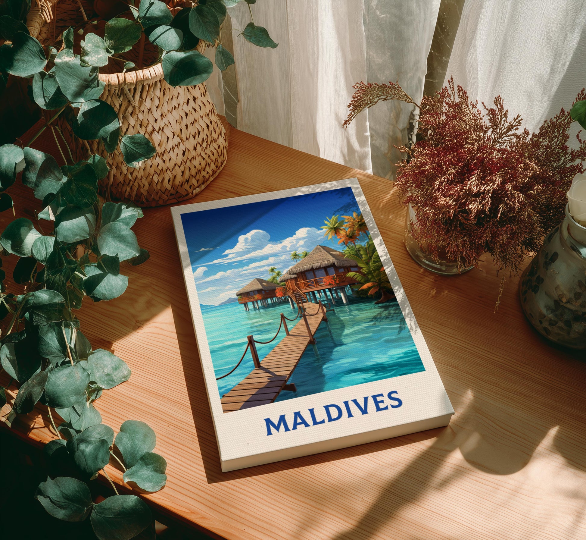 Canvas of 'Maldives' with a scenic illustration on a wooden table with plants.