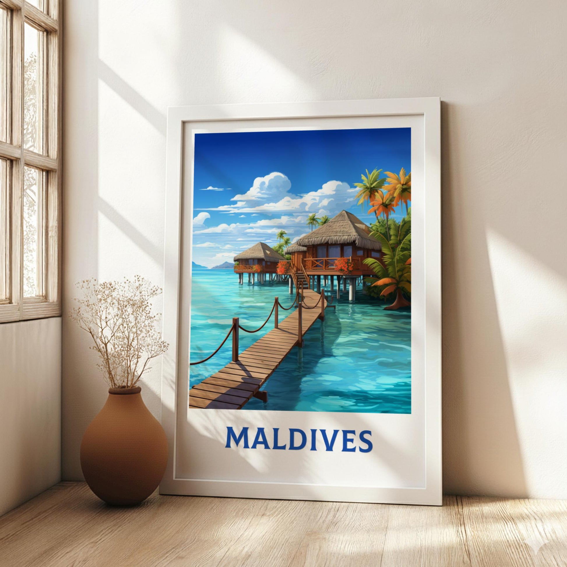 Framed artwork of the Maldives with a wooden dock and tropical houses, placed on a light wooden floor.