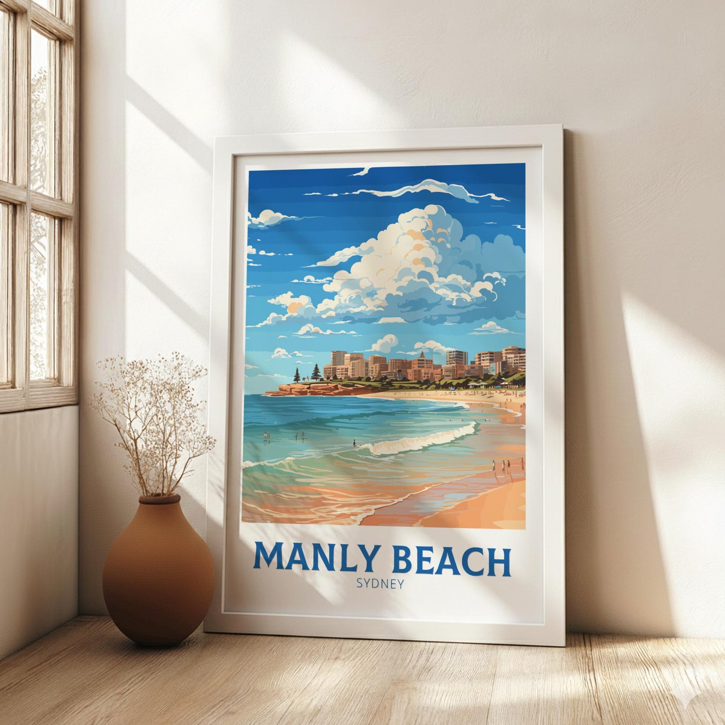 Framed artwork of Manly Beach, Sydney on a wall in a bright room.