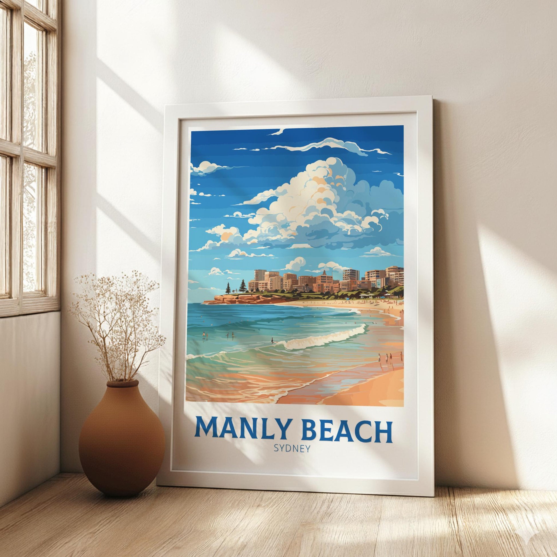 Framed artwork of Manly Beach, Sydney on a wall in a bright room.