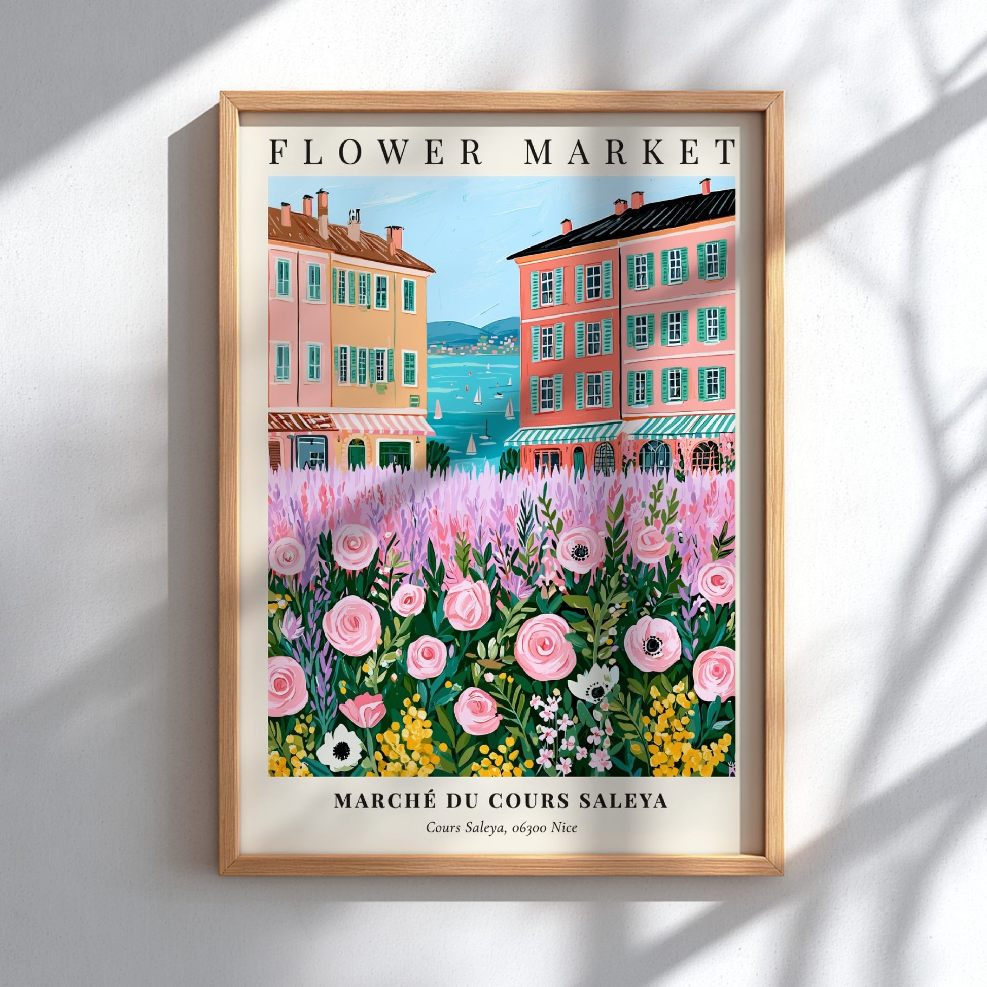 Flower market art print featuring pink flowers and colorful buildings by the sea in a whimsical style