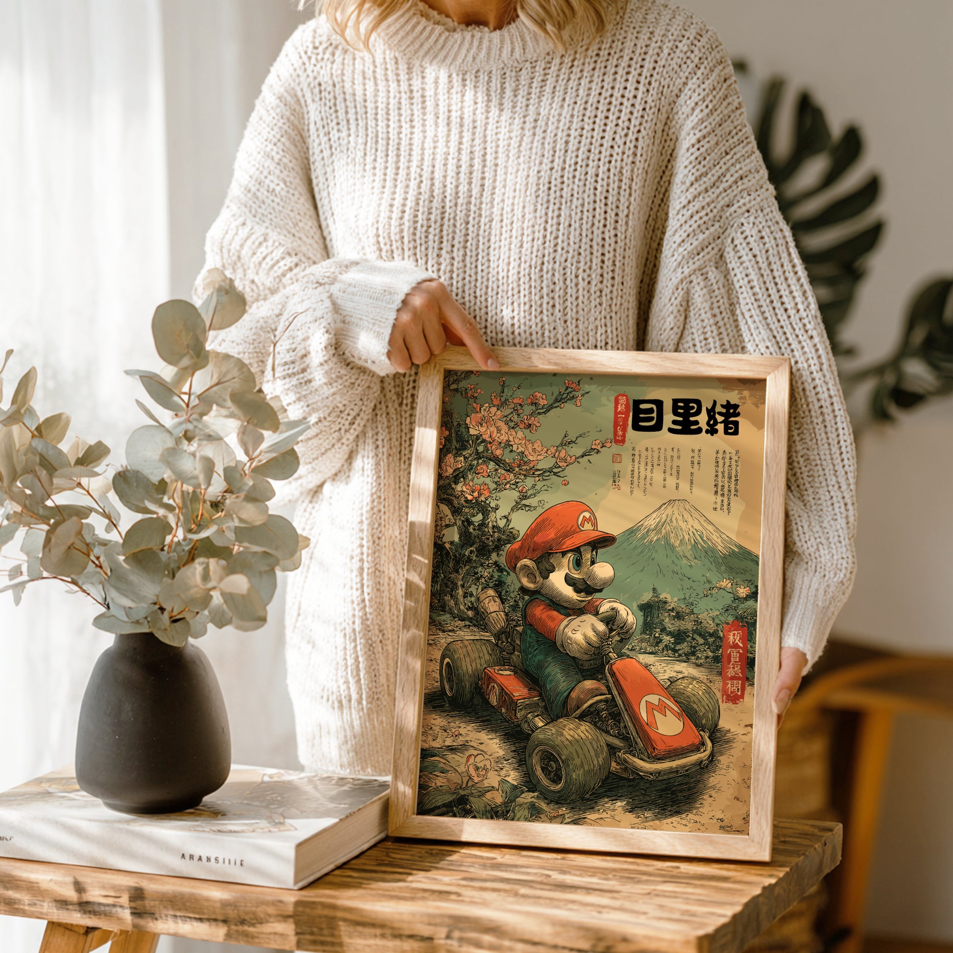 Person holding a framed artwork of Super Mario in a kart with Mount Fuji in the background