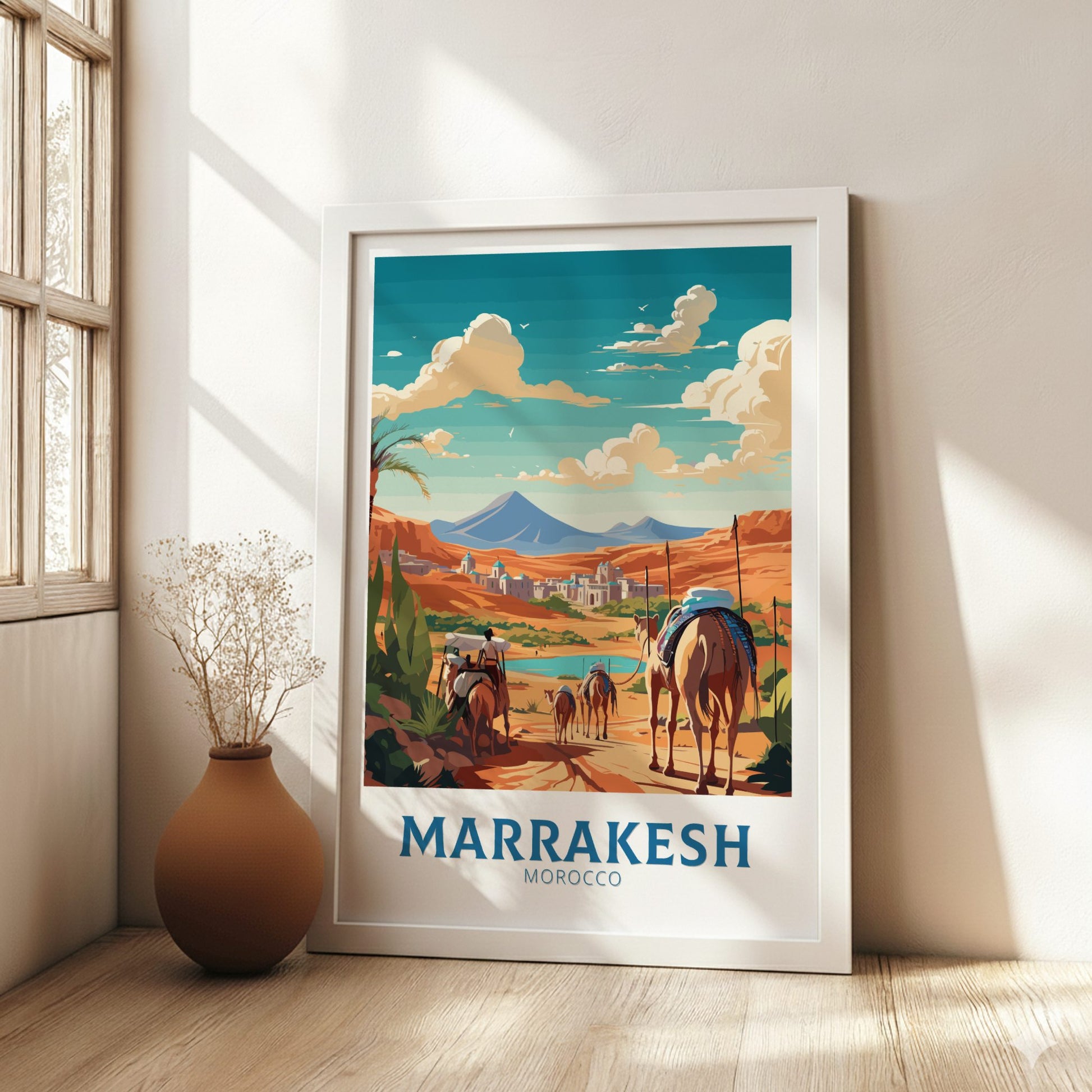 Framed artwork of Marrakesh, Morocco with a camel and people on a path, in a bright room.