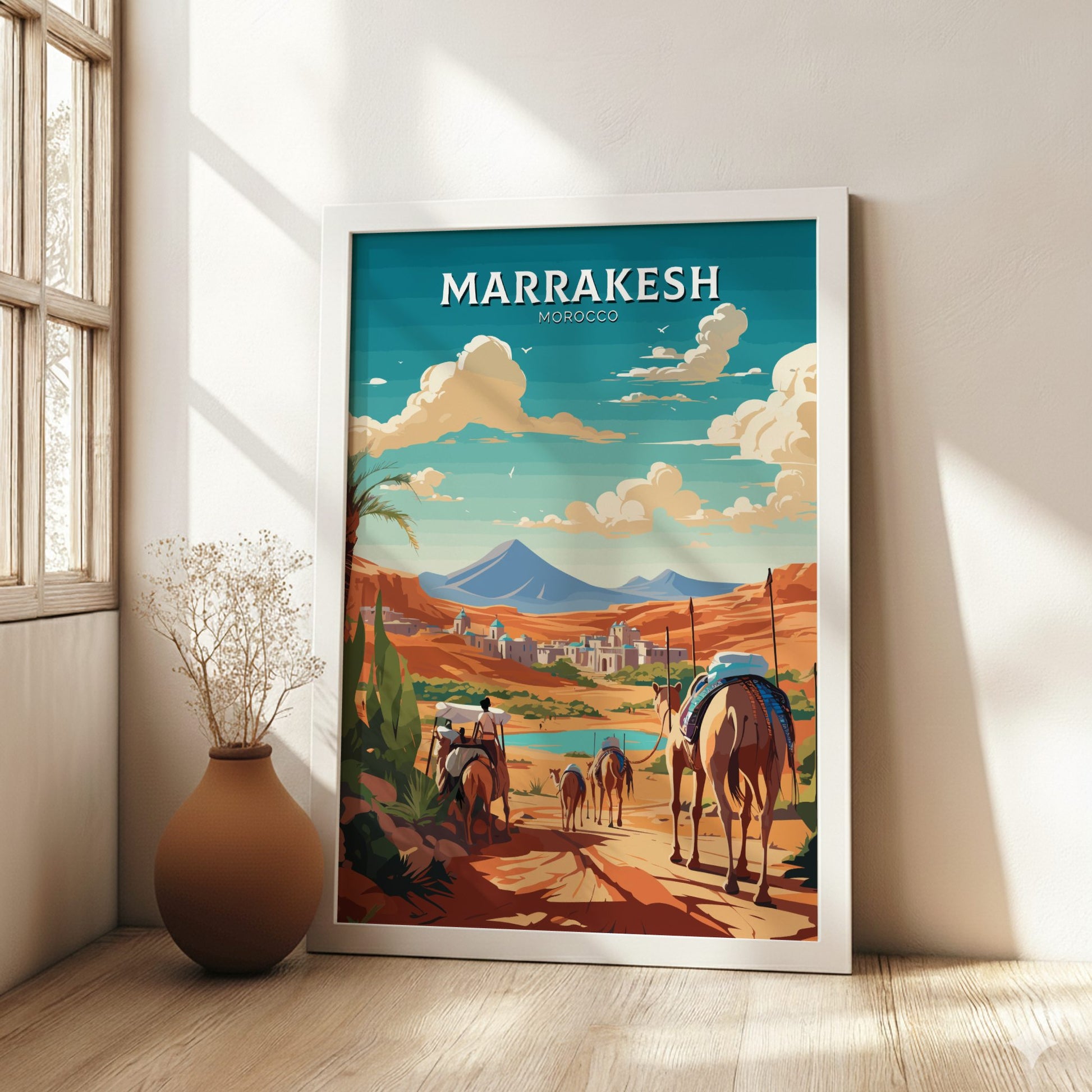 Framed artwork of Marrakesh, Morocco with horses and mountains in a room with a vase.