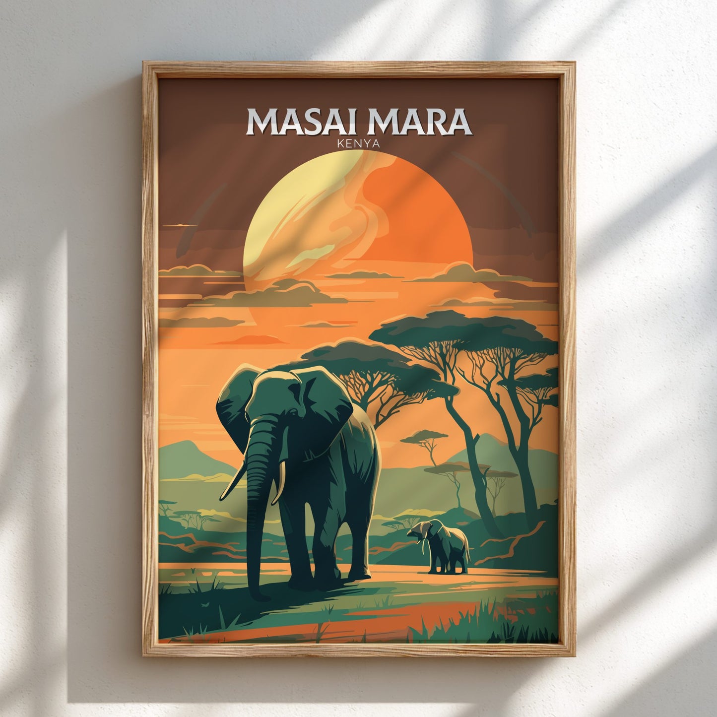 Framed artwork of an elephant and calf in a Masai Mara landscape with a sunset.