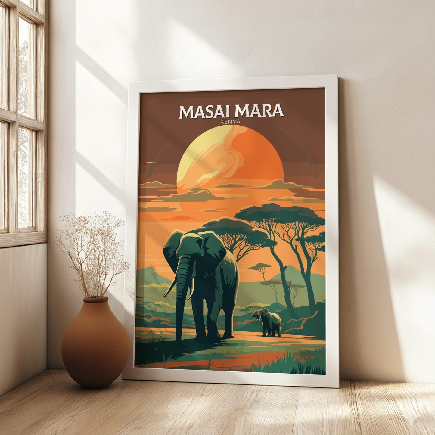 Framed poster of an elephant and calf in a Masai Mara landscape on a wall.