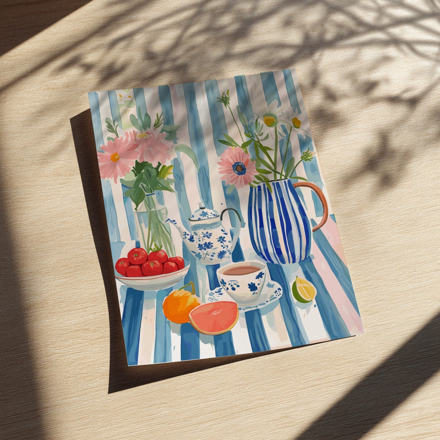 Framed artwork of a still life scene with flowers, teacups, and fruits on a striped background.