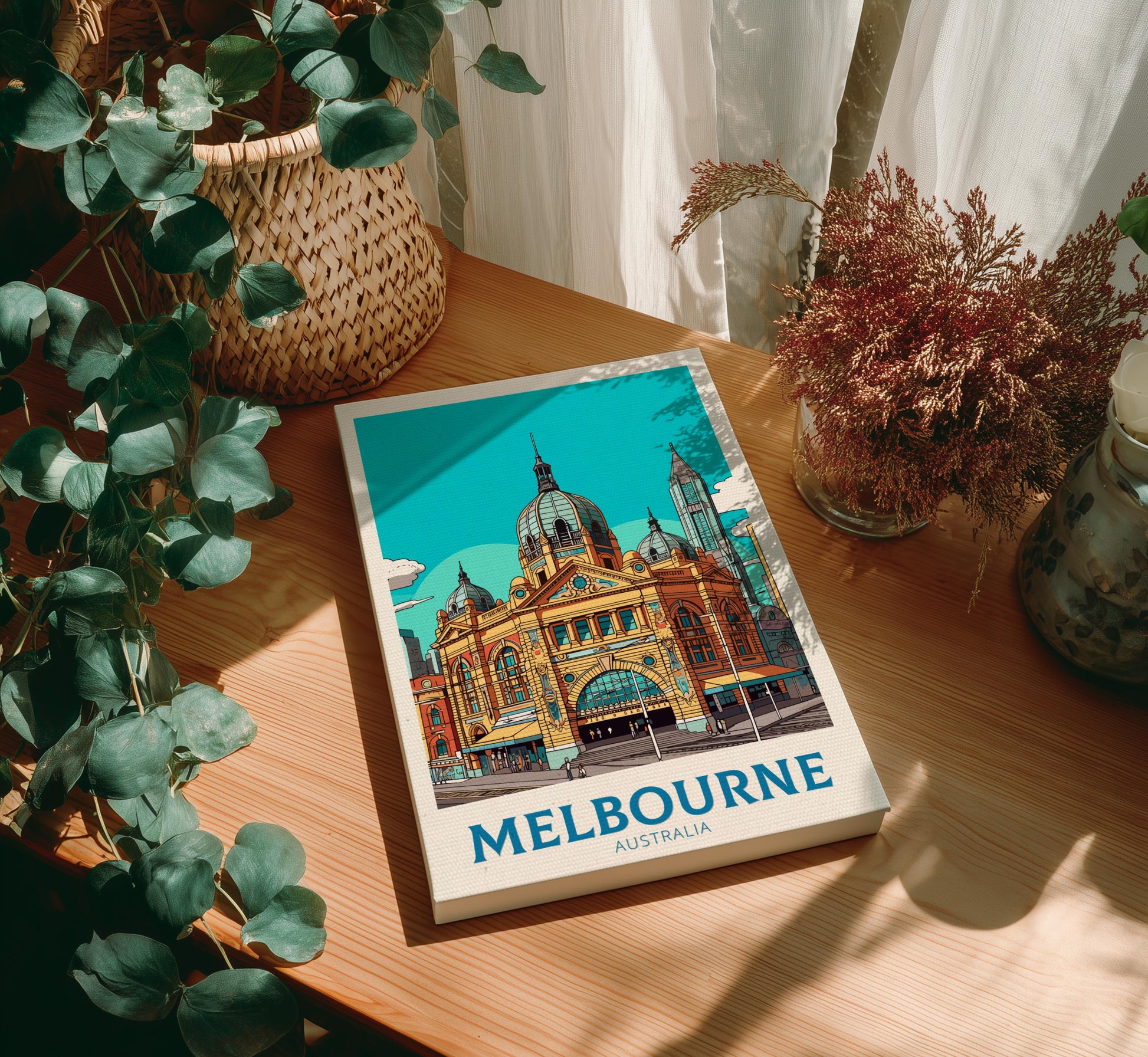 Canvas with Melbourne illustration on a wooden table with plants