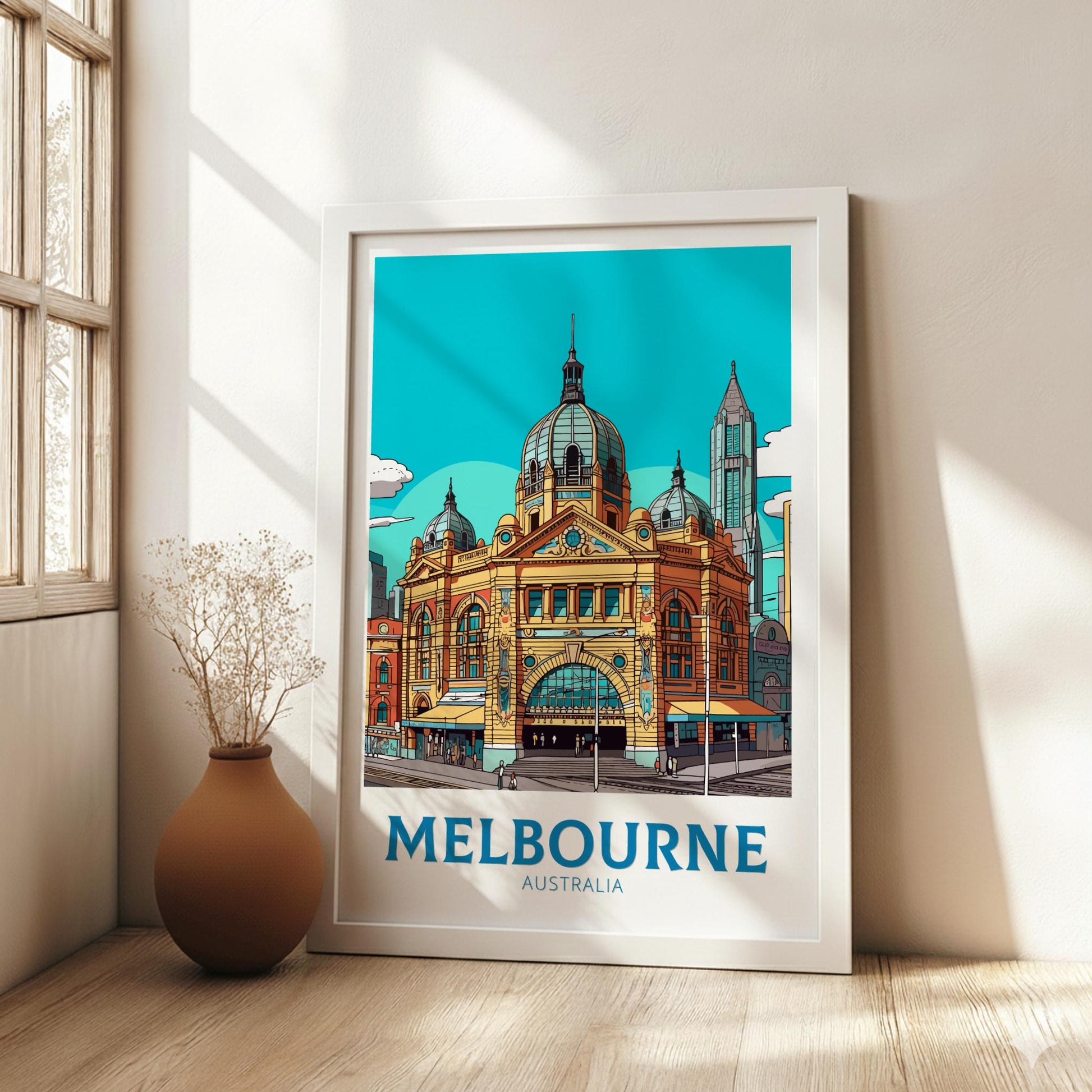 Framed poster of a Melbourne landmark with 'Melbourne Australia' text in a room with a vase and plant.