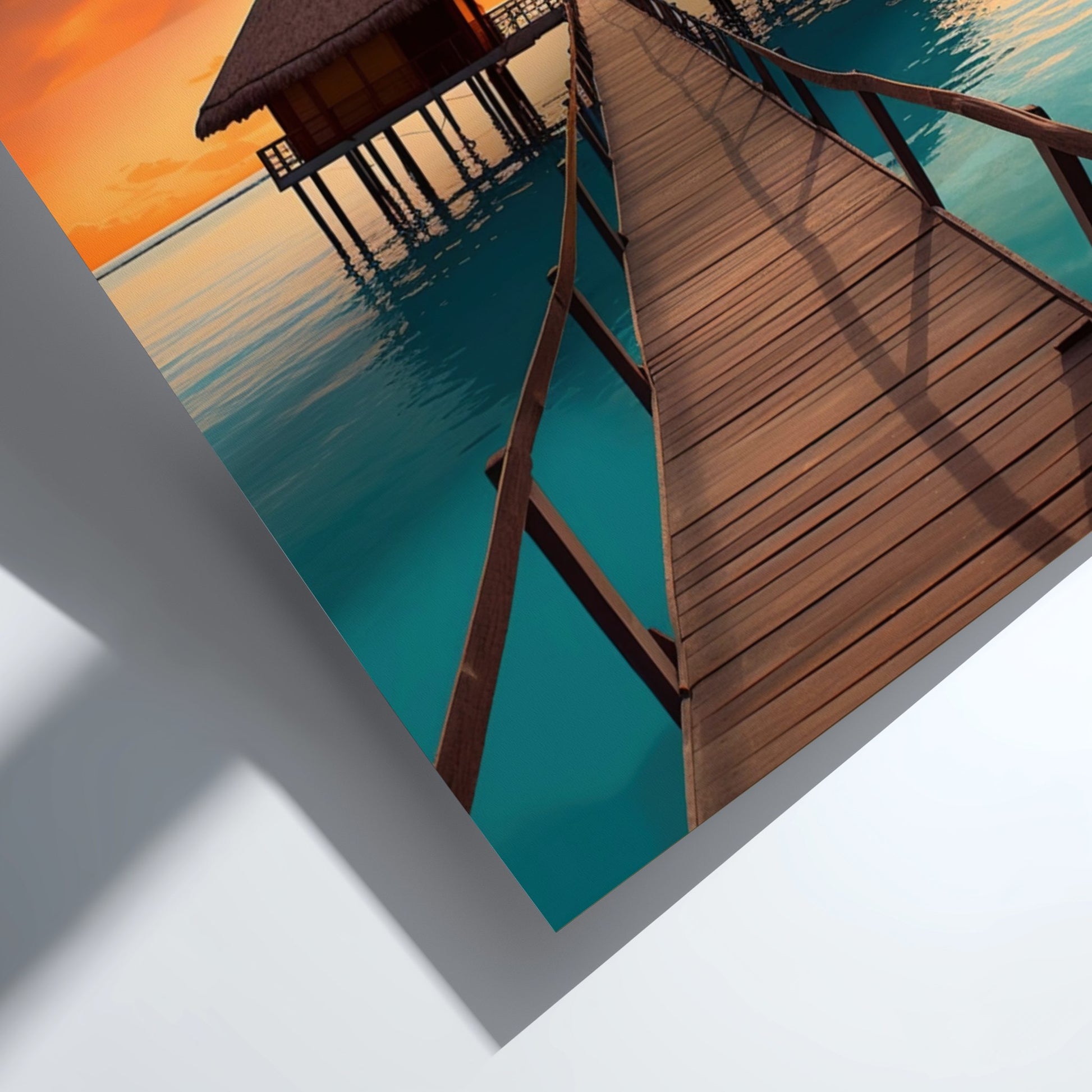 Wooden pier extending into a body of water with a hut at sunset.