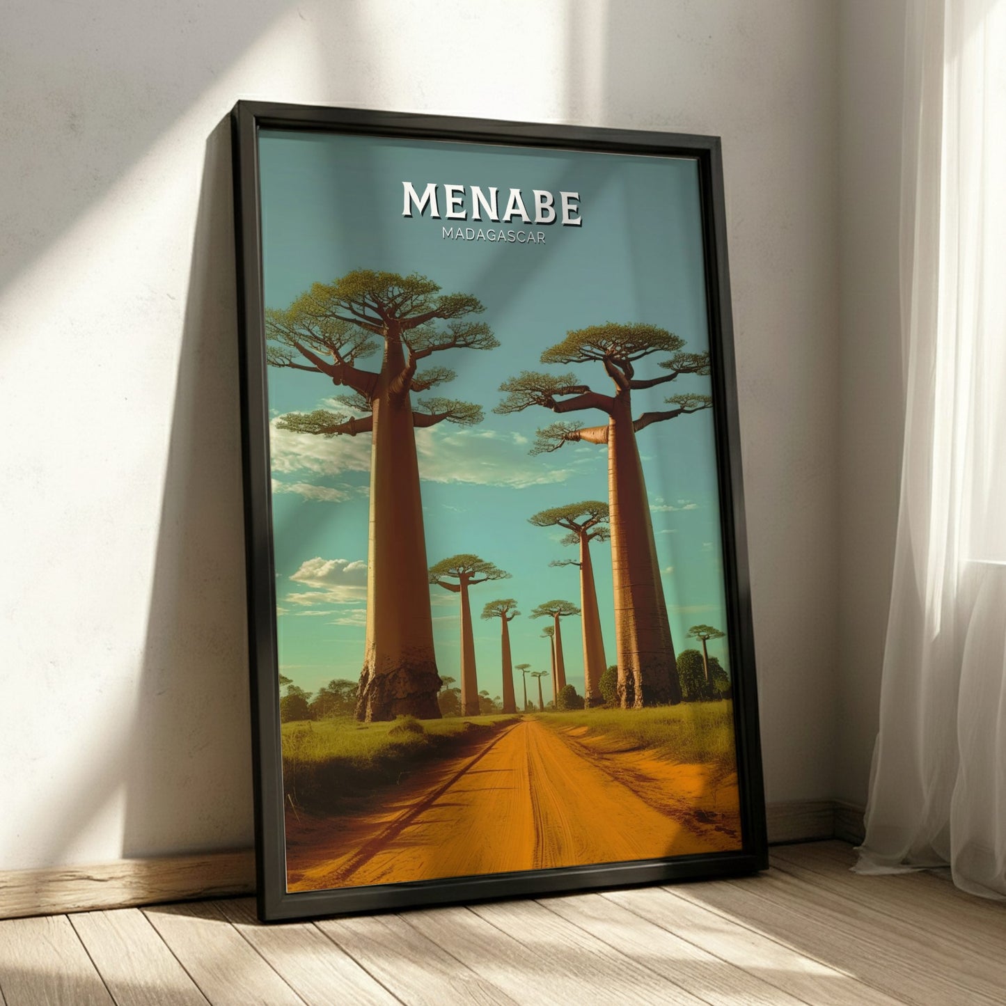 Framed artwork of a scenic landscape with trees and 'Menabe Madagascar' text on a wall.