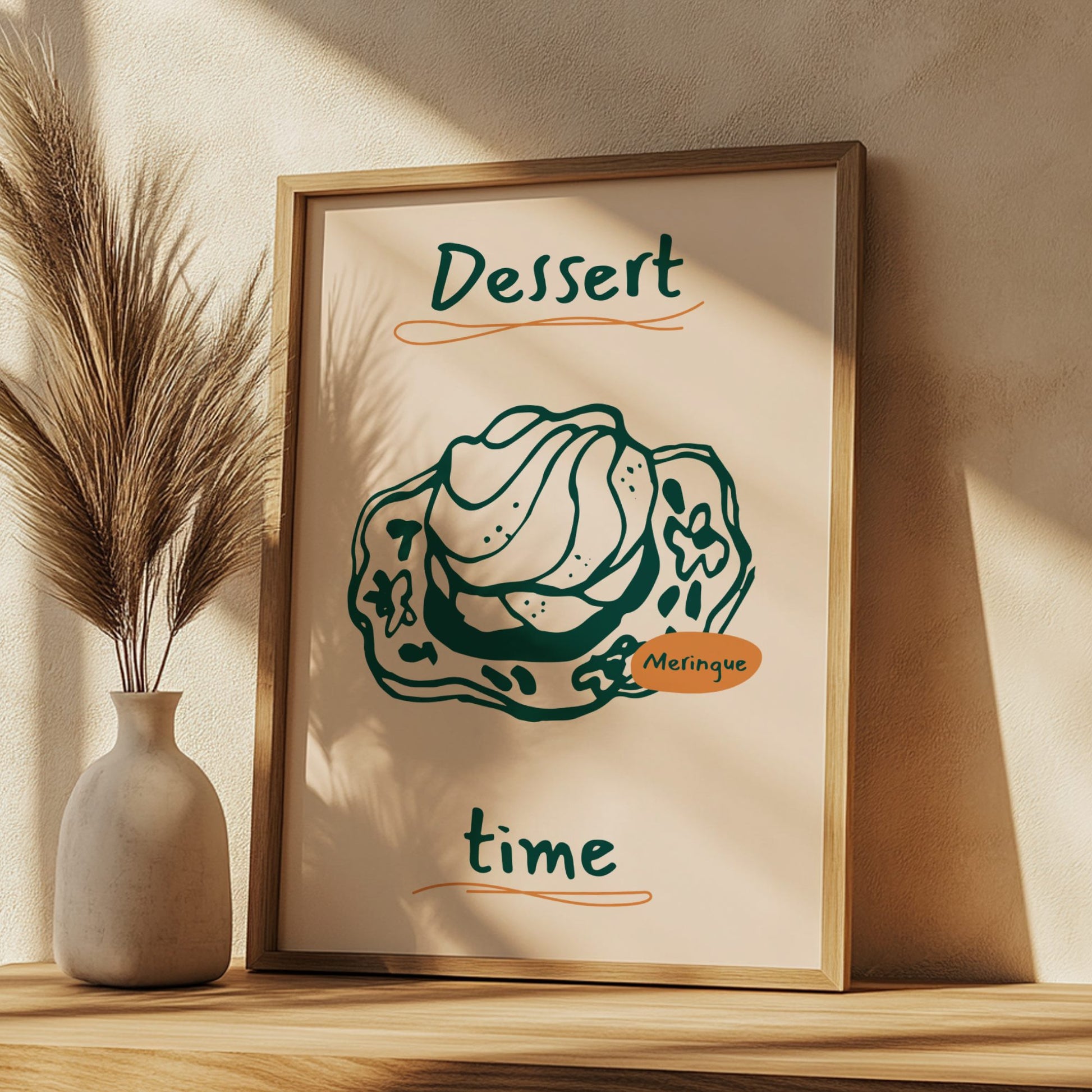 Framed artwork with a dessert illustration and text on a wall with a vase and plant.