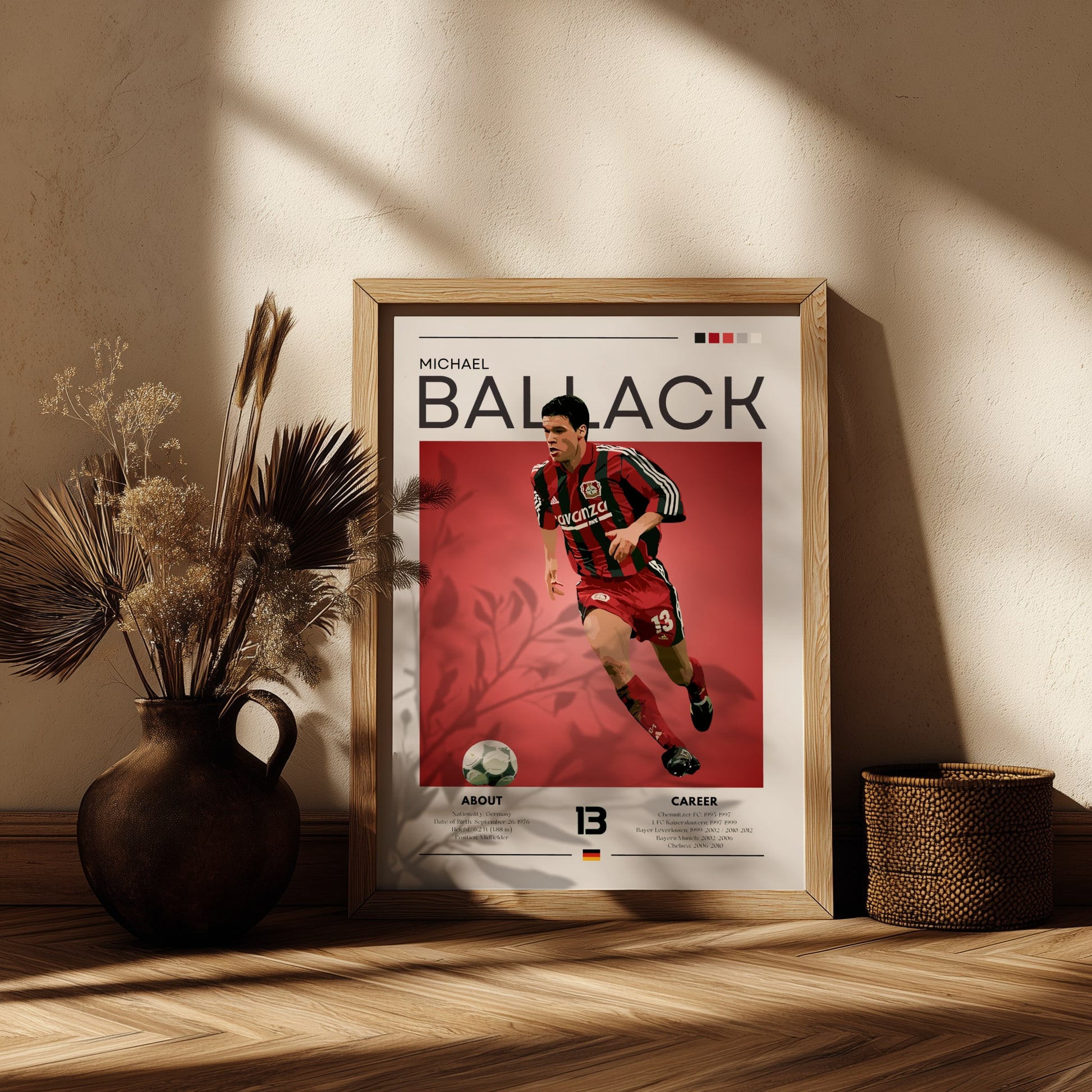 Framed poster of a soccer player on a wooden shelf with decorative plants.
