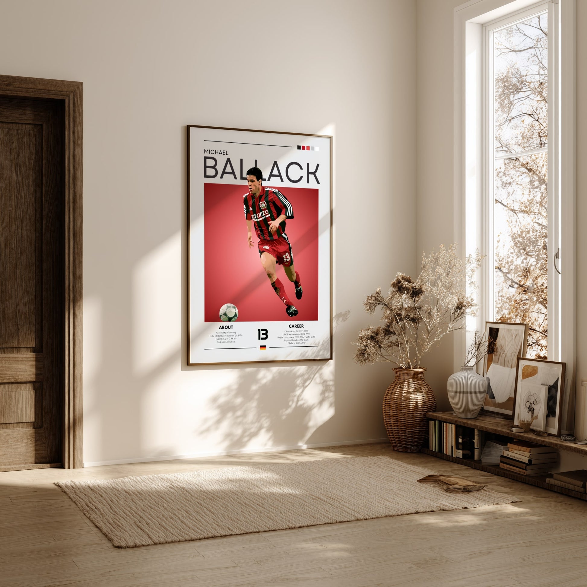Framed sports poster of a soccer player on a wall in a bright room with natural light.