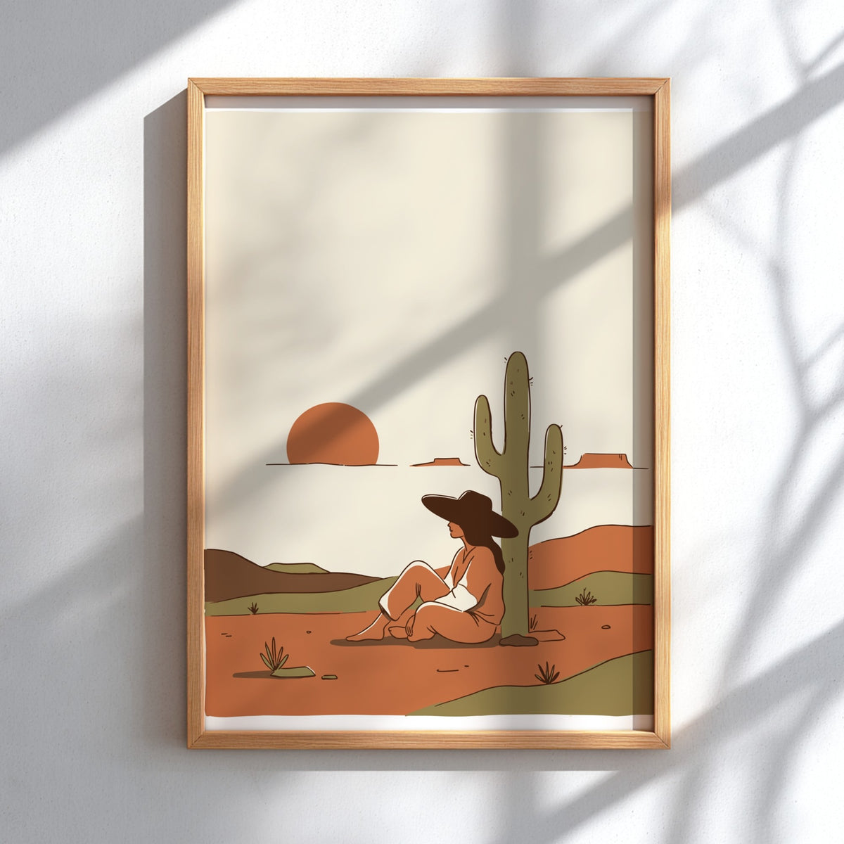 Poster of a woman sitting under a saguaro cactus during a desert sunset