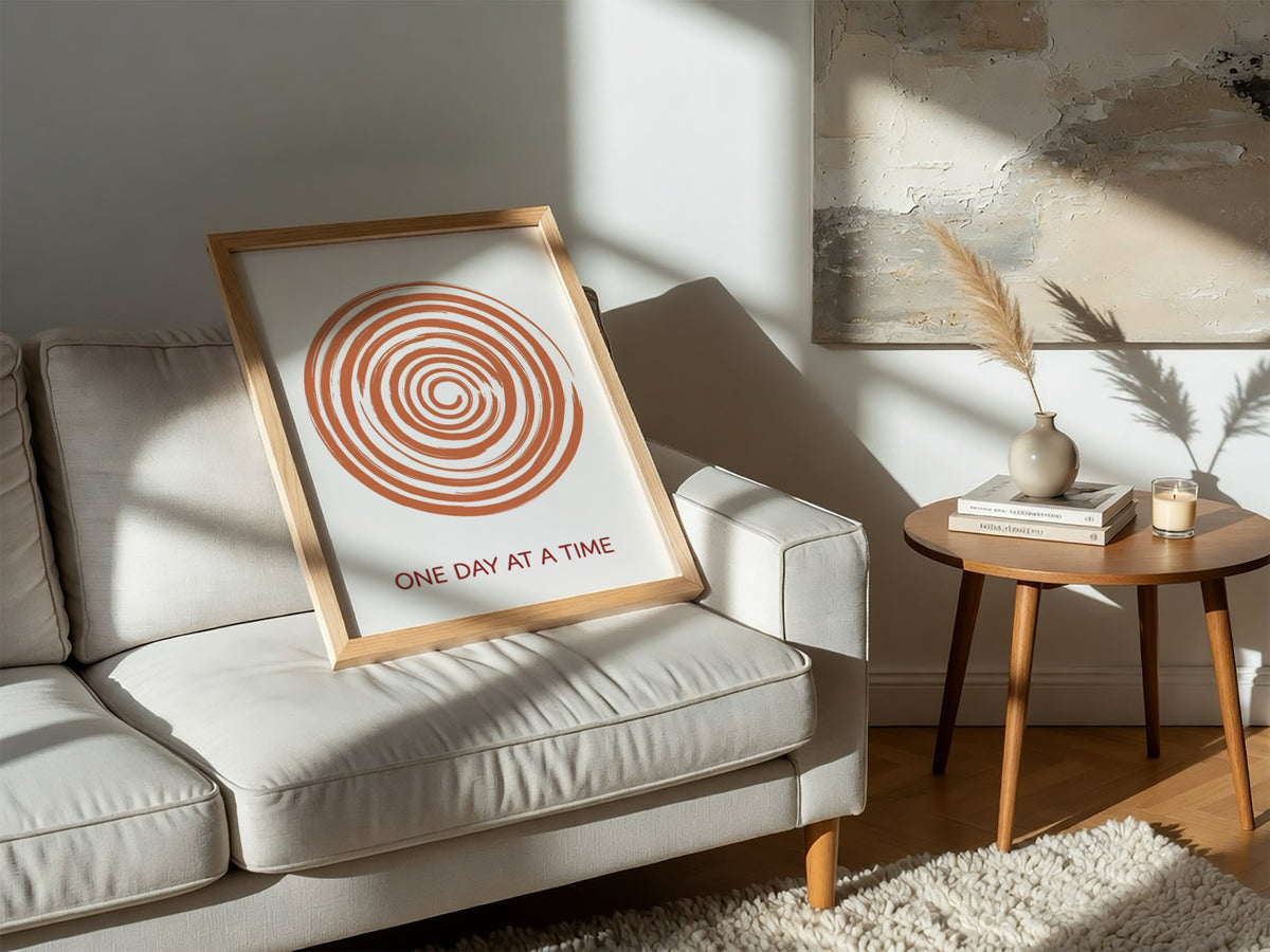 Motivational poster showing a burnt orange hand drawn spiral with One Day At A Time.