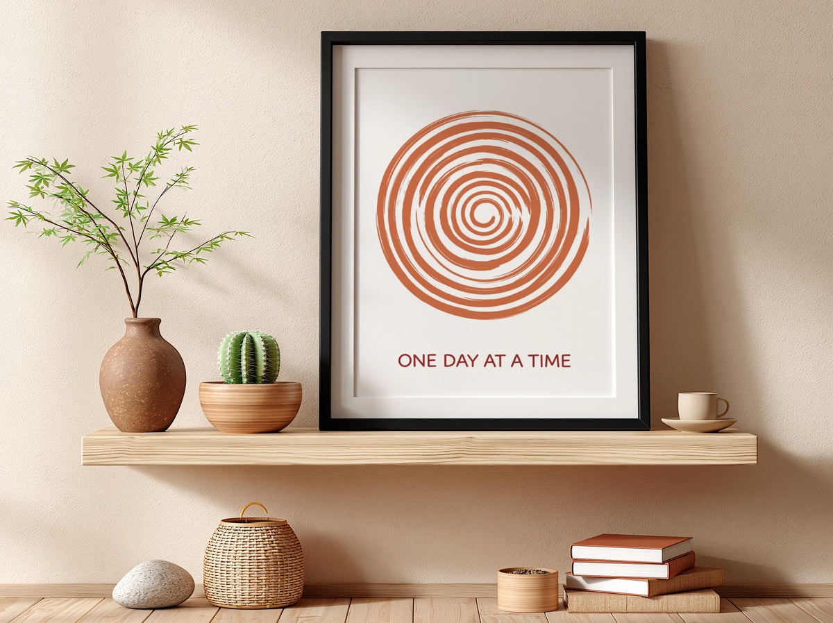Motivational poster showing a burnt orange hand drawn spiral with One Day At A Time.