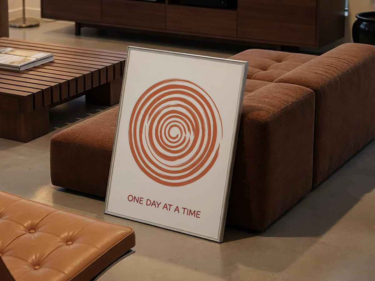 Motivational poster showing a burnt orange hand drawn spiral with One Day At A Time.