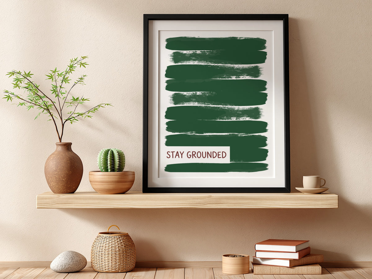 Motivational poster featuring deep forest green brush strokes with the text Stay Grounded