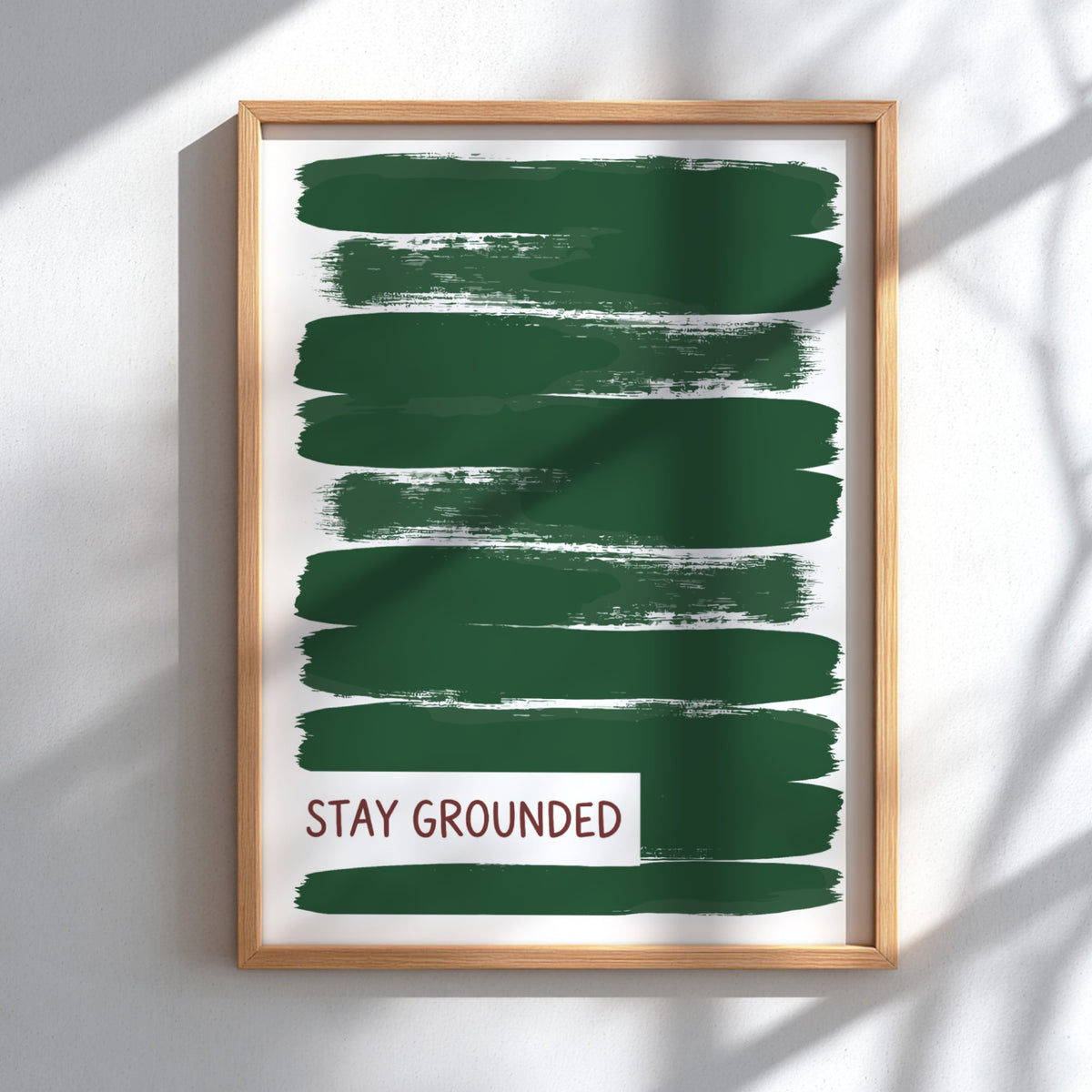 Motivational poster featuring deep forest green brush strokes with the text Stay Grounded