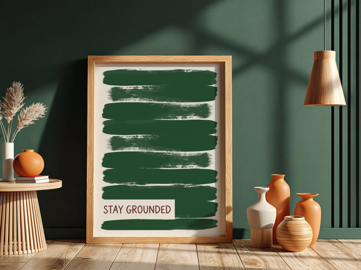 Motivational poster featuring deep forest green brush strokes with the text Stay Grounded
