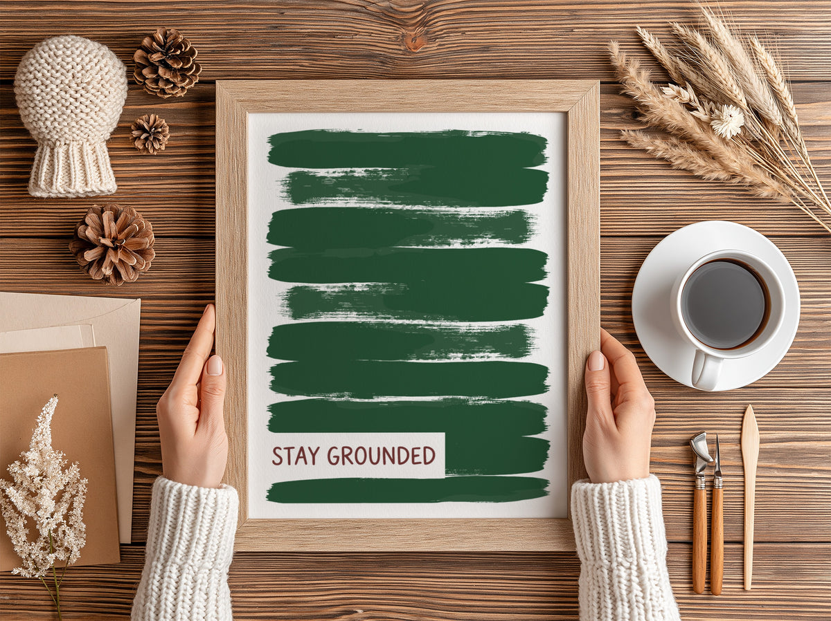 Motivational poster featuring deep forest green brush strokes with the text Stay Grounded