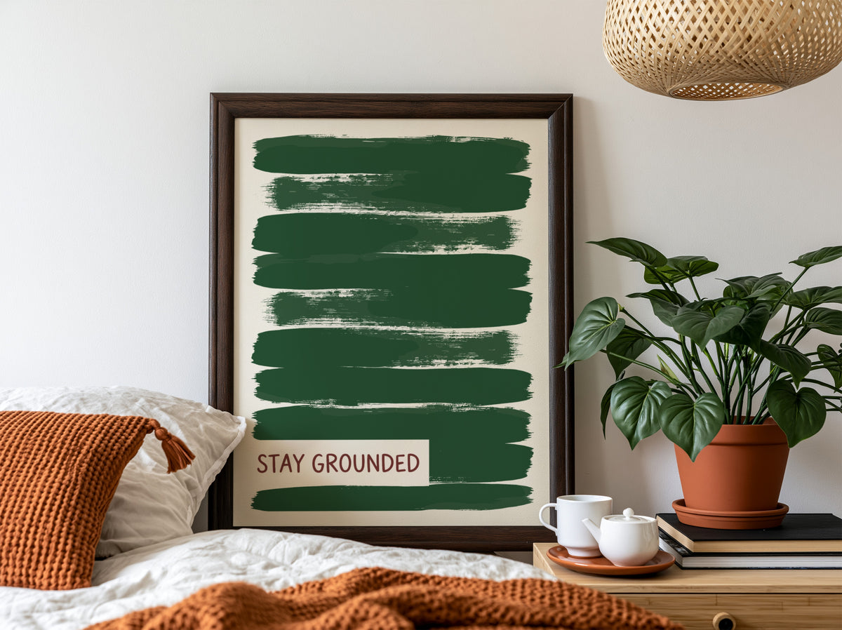 Motivational poster featuring deep forest green brush strokes with the text Stay Grounded