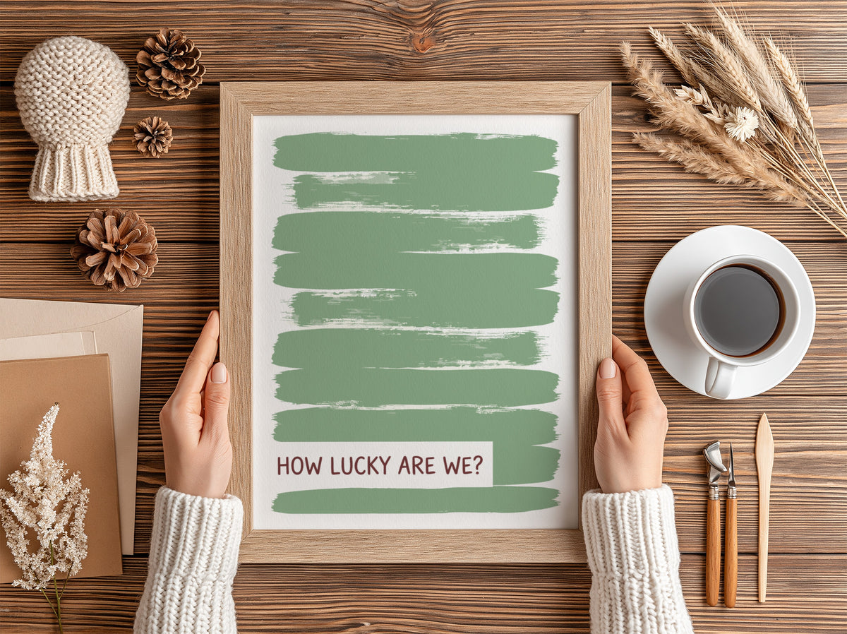 Motivational poster with sage green brushstrokes and the text How Lucky Are We displayed.