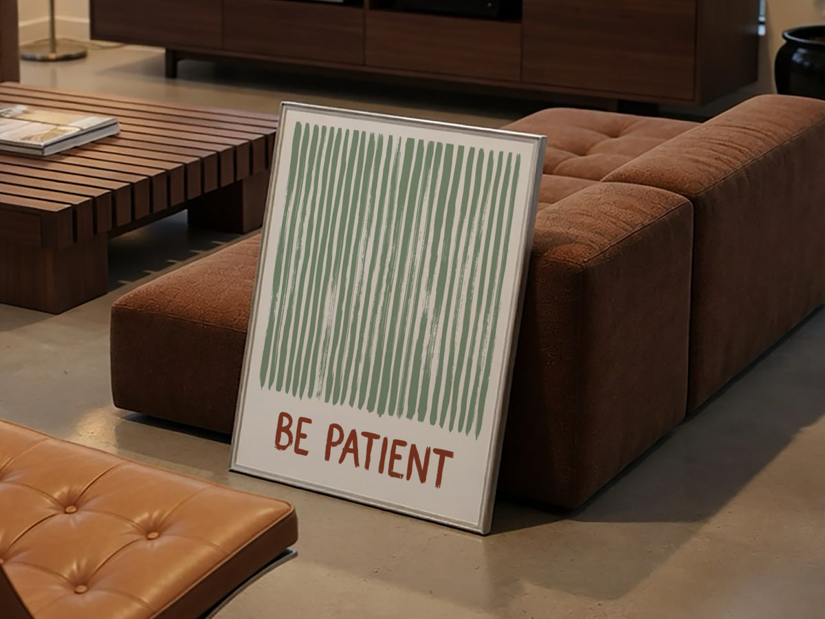 Motivational poster with sage green vertical brushstrokes and the text Be Patient in terracotta.