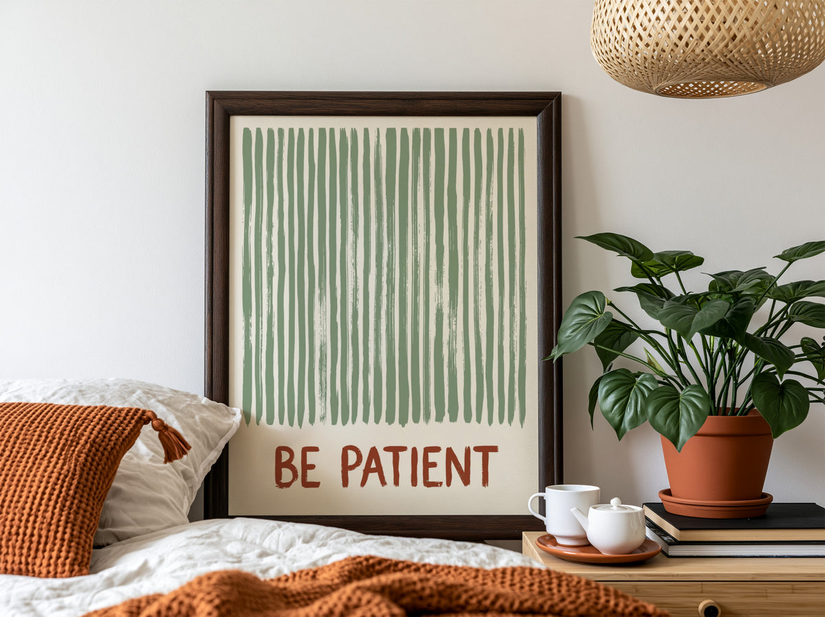 Motivational poster with sage green vertical brushstrokes and the text Be Patient in terracotta.