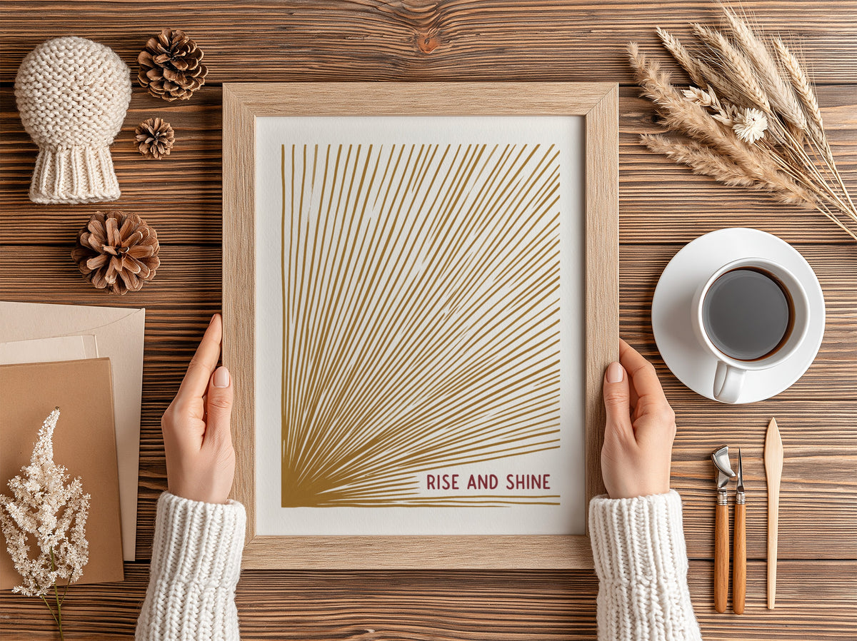 Motivational poster with golden sunburst lines on cream background and Rise and Shine text