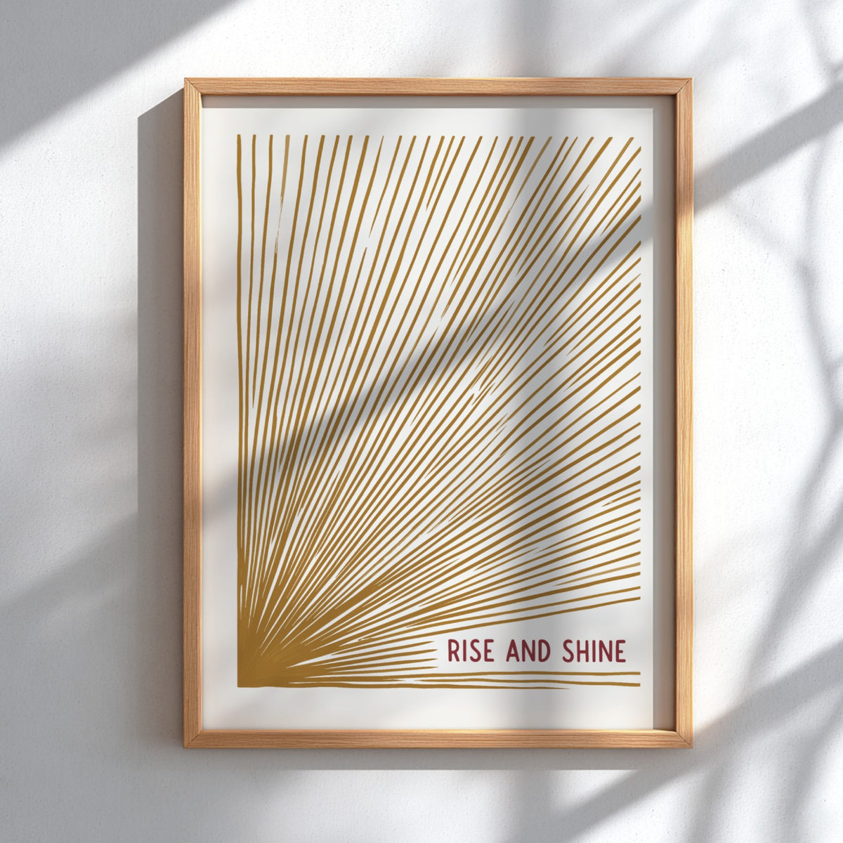 Motivational poster with golden sunburst lines on cream background and Rise and Shine text
