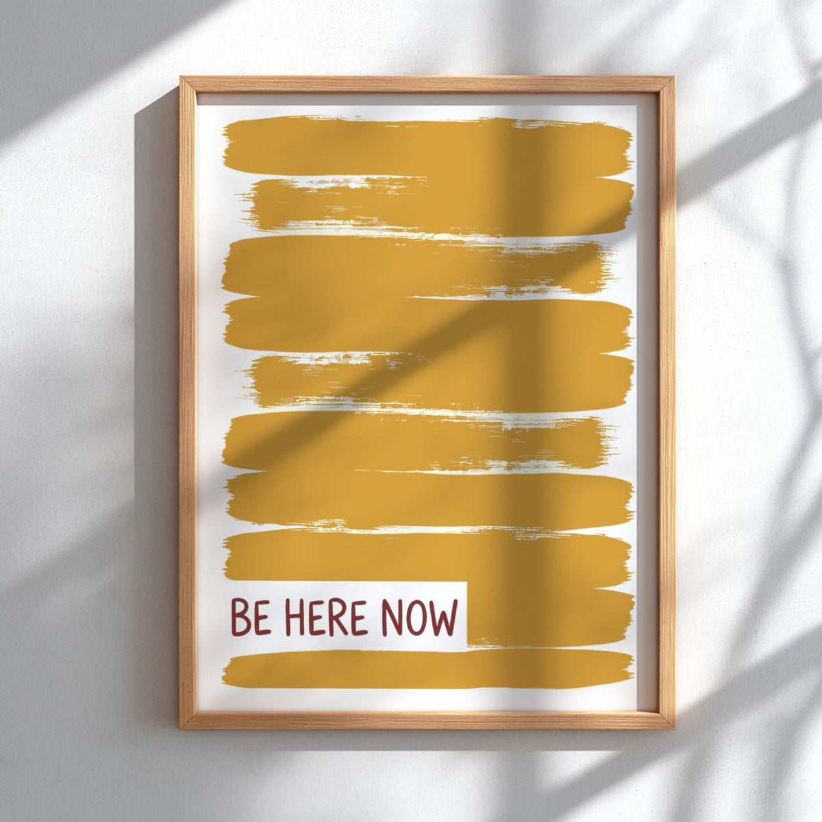 Motivational poster with yellow brushstrokes and the text Be Here Now in brown