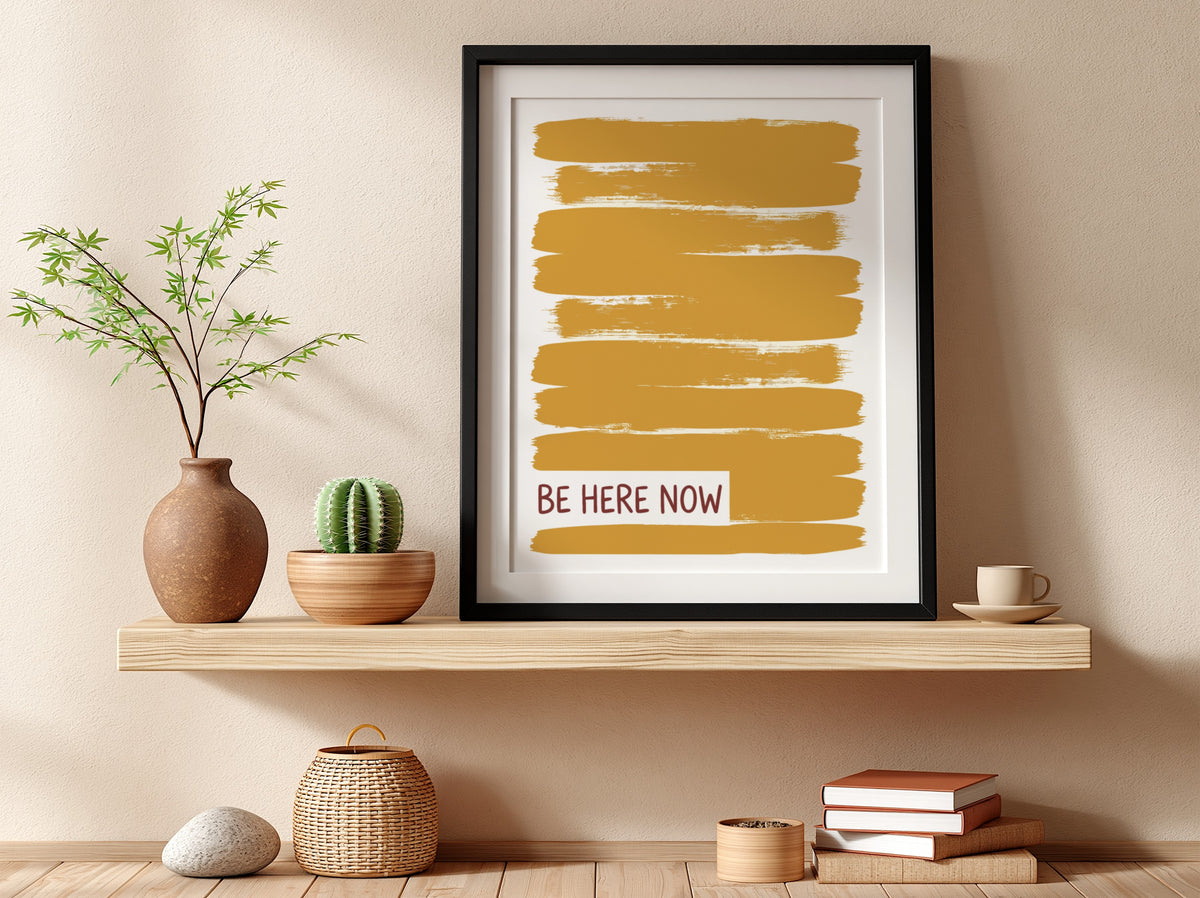 Motivational poster with yellow brushstrokes and the text Be Here Now in brown