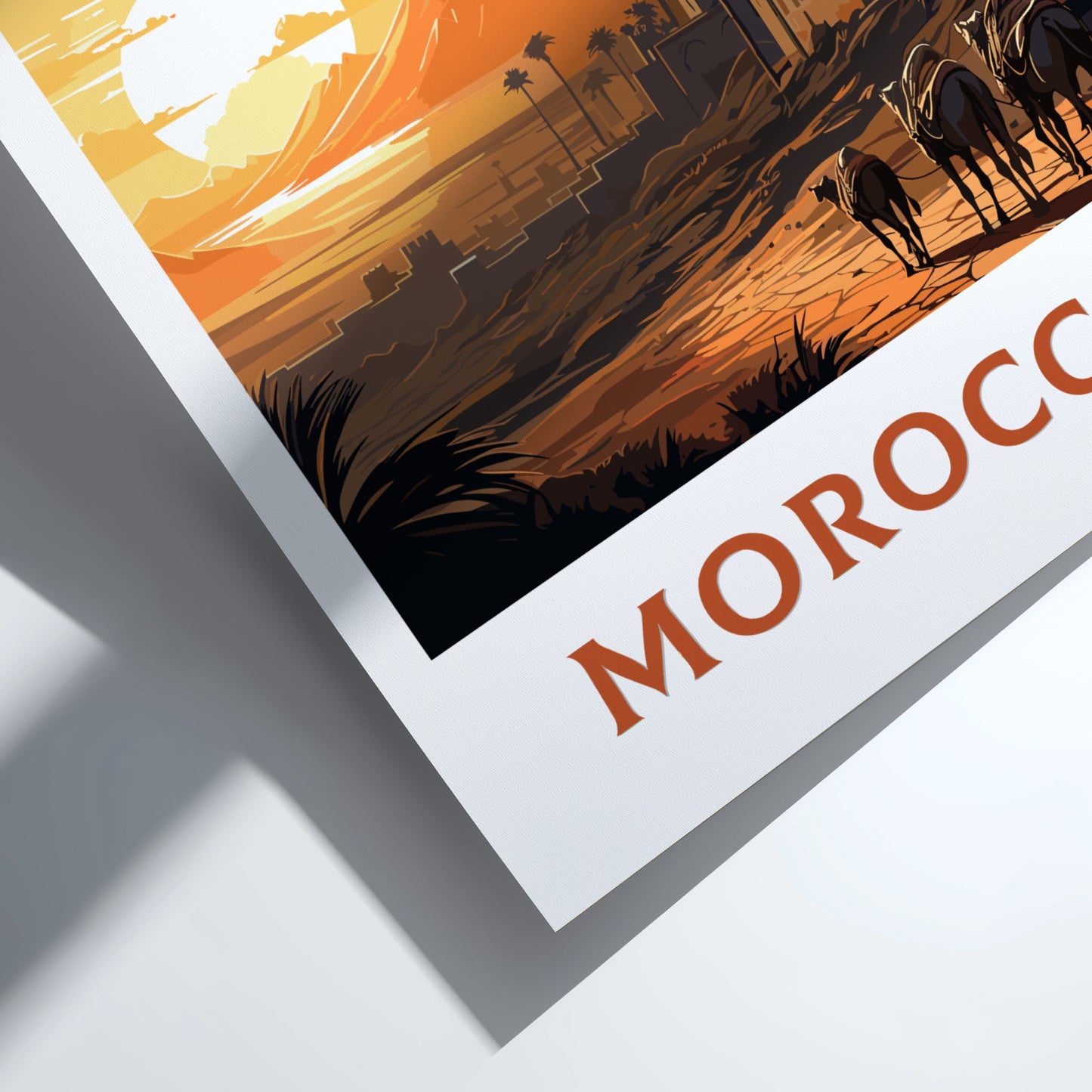 Framed artwork of a desert scene with camels and 'Morocco' text.