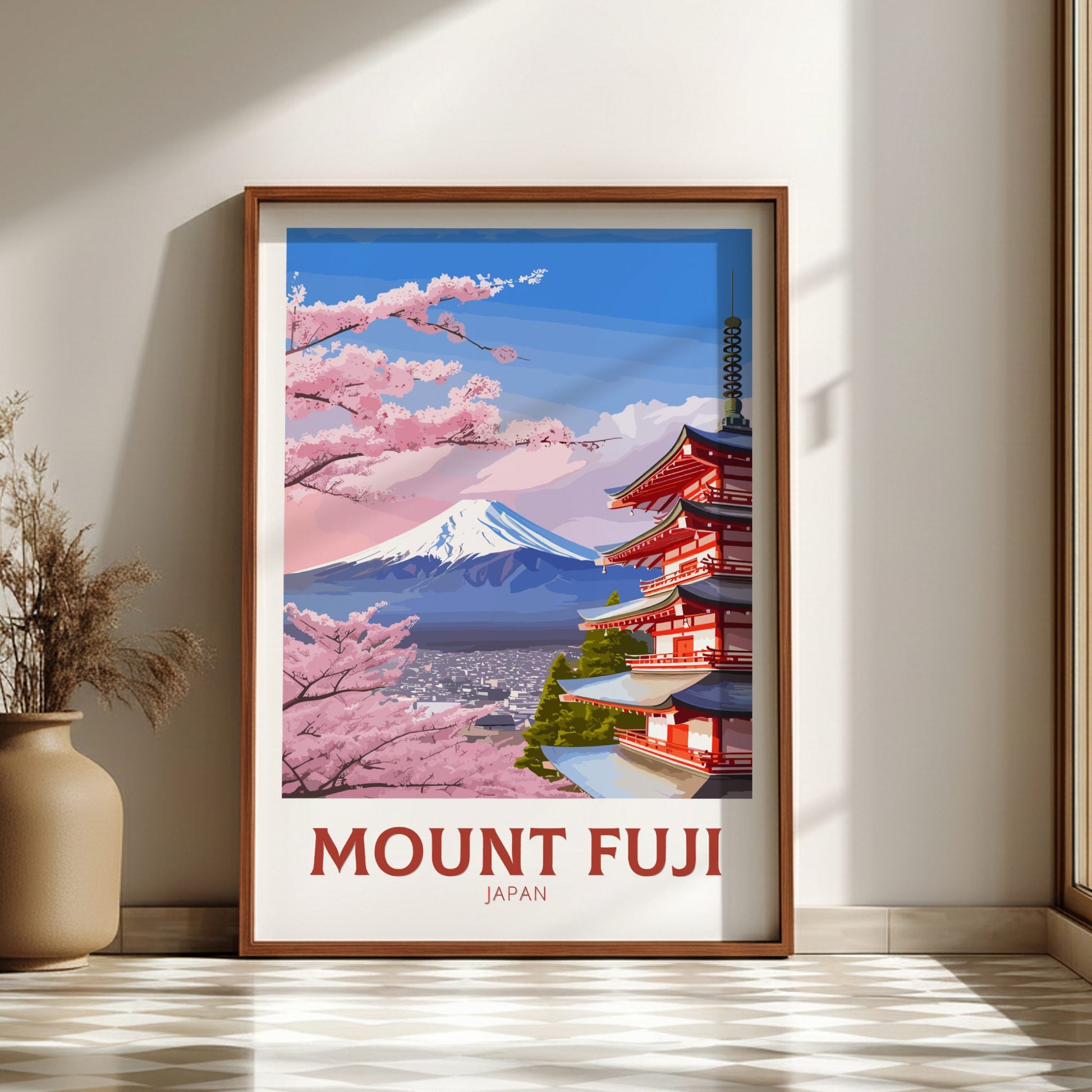 Framed poster of Mount Fuji with cherry blossoms and a temple, placed on a light wooden floor.