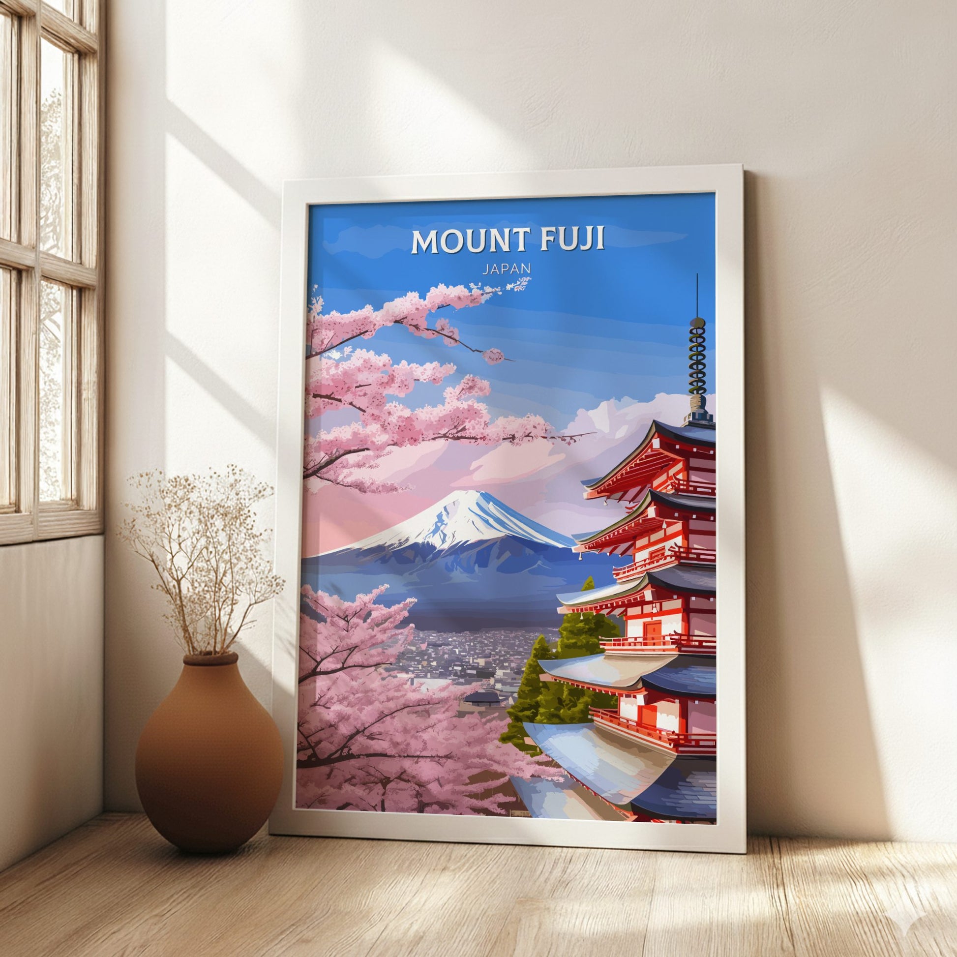 Framed poster of Mount Fuji and cherry blossoms in a room with a vase on a wooden floor.