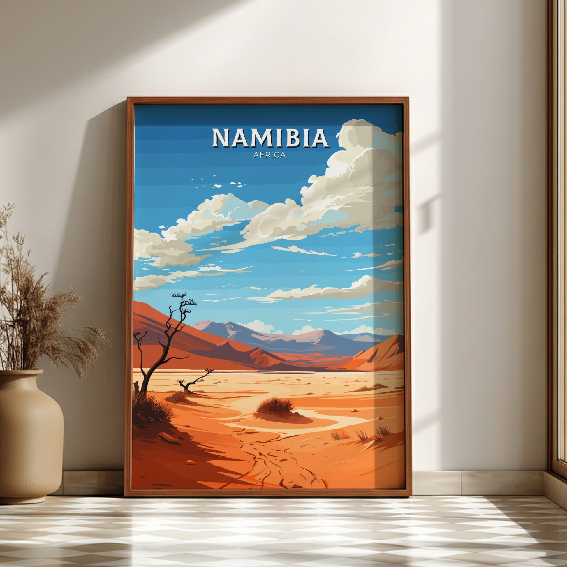 Framed artwork of a desert landscape with mountains and 'Namibia, Africa' text on a wall.