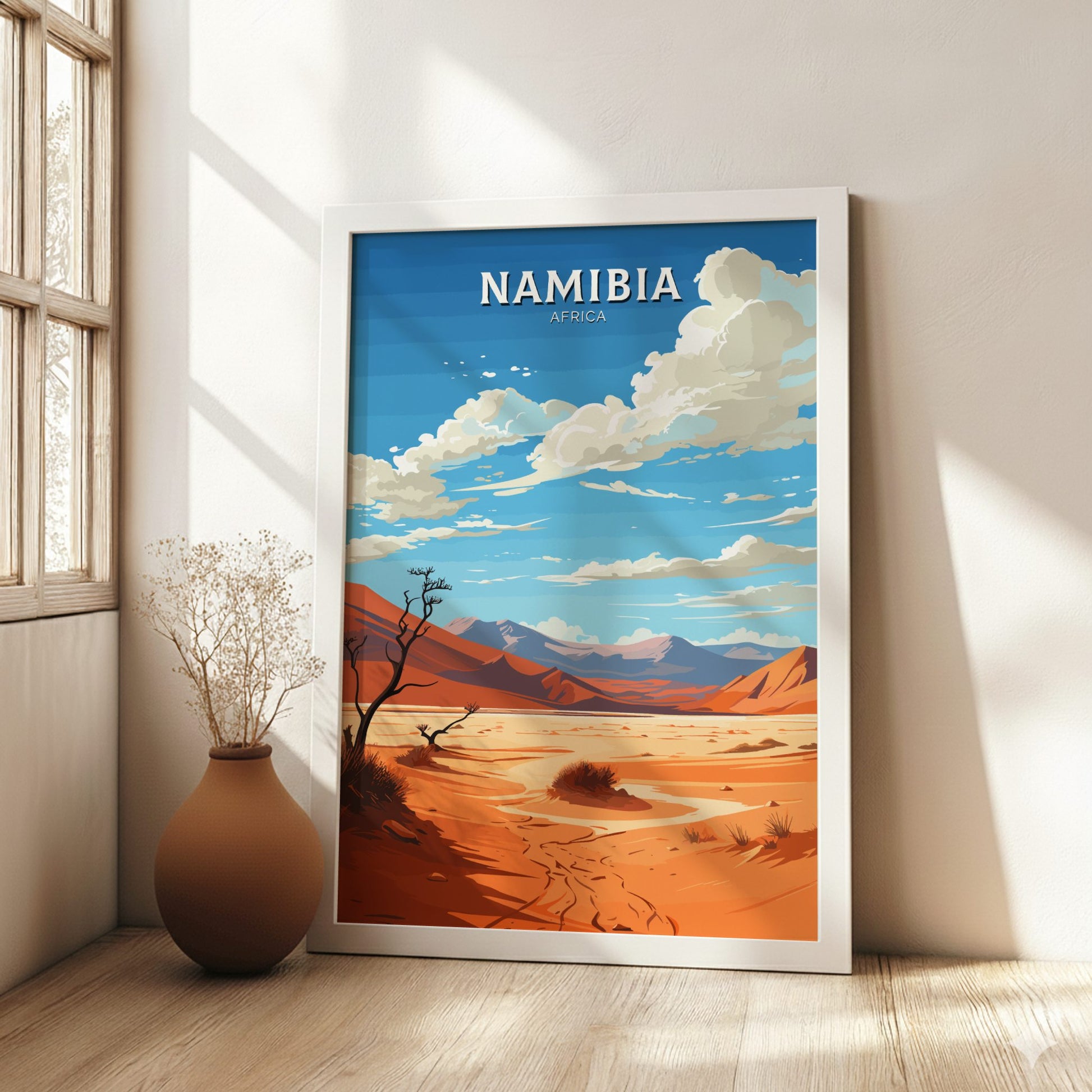 Framed artwork of Namibia with a desert landscape and blue sky.