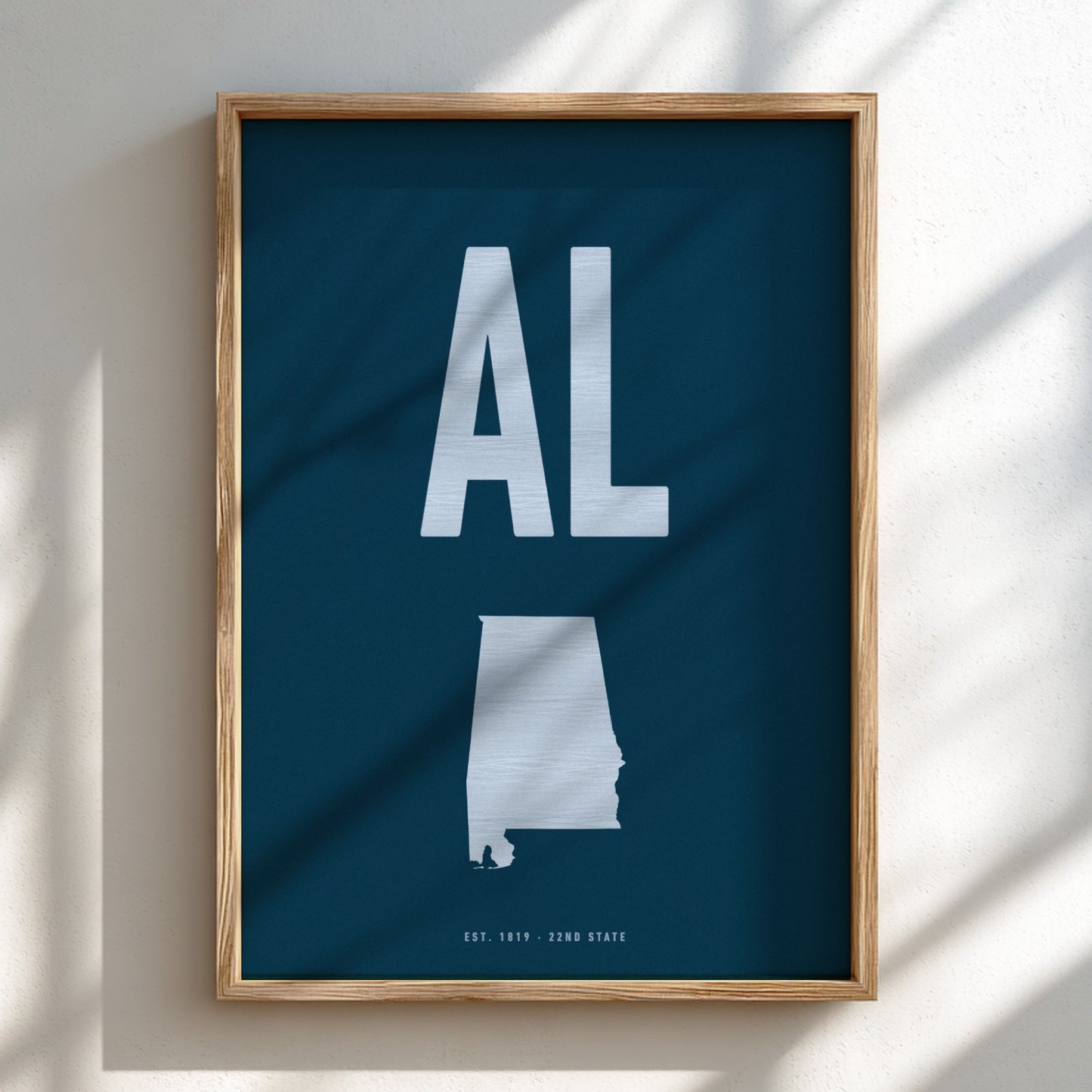 Framed poster with 'AL' and a map of Alabama on a blue background