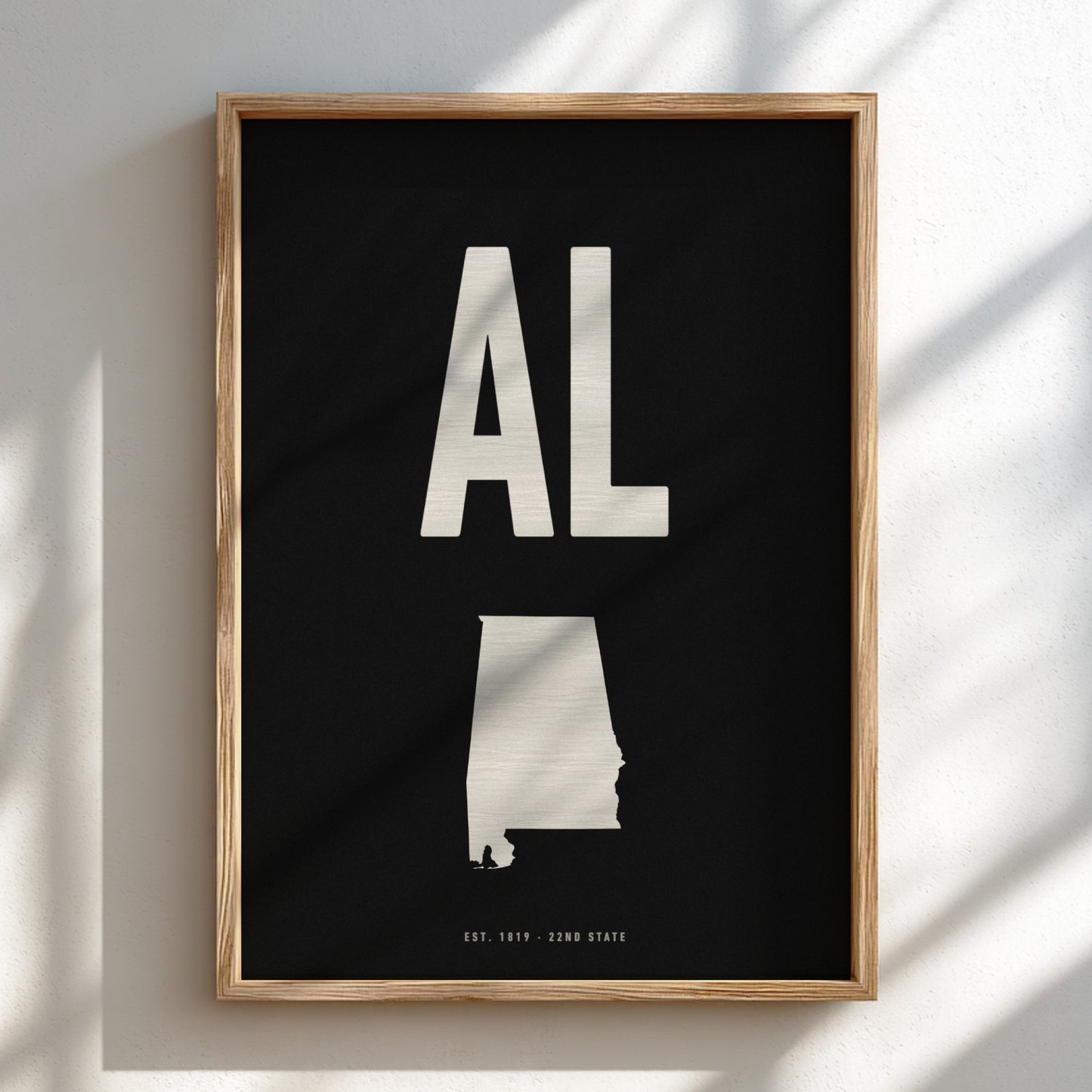 Framed poster with 'AL' and state outline on a black background