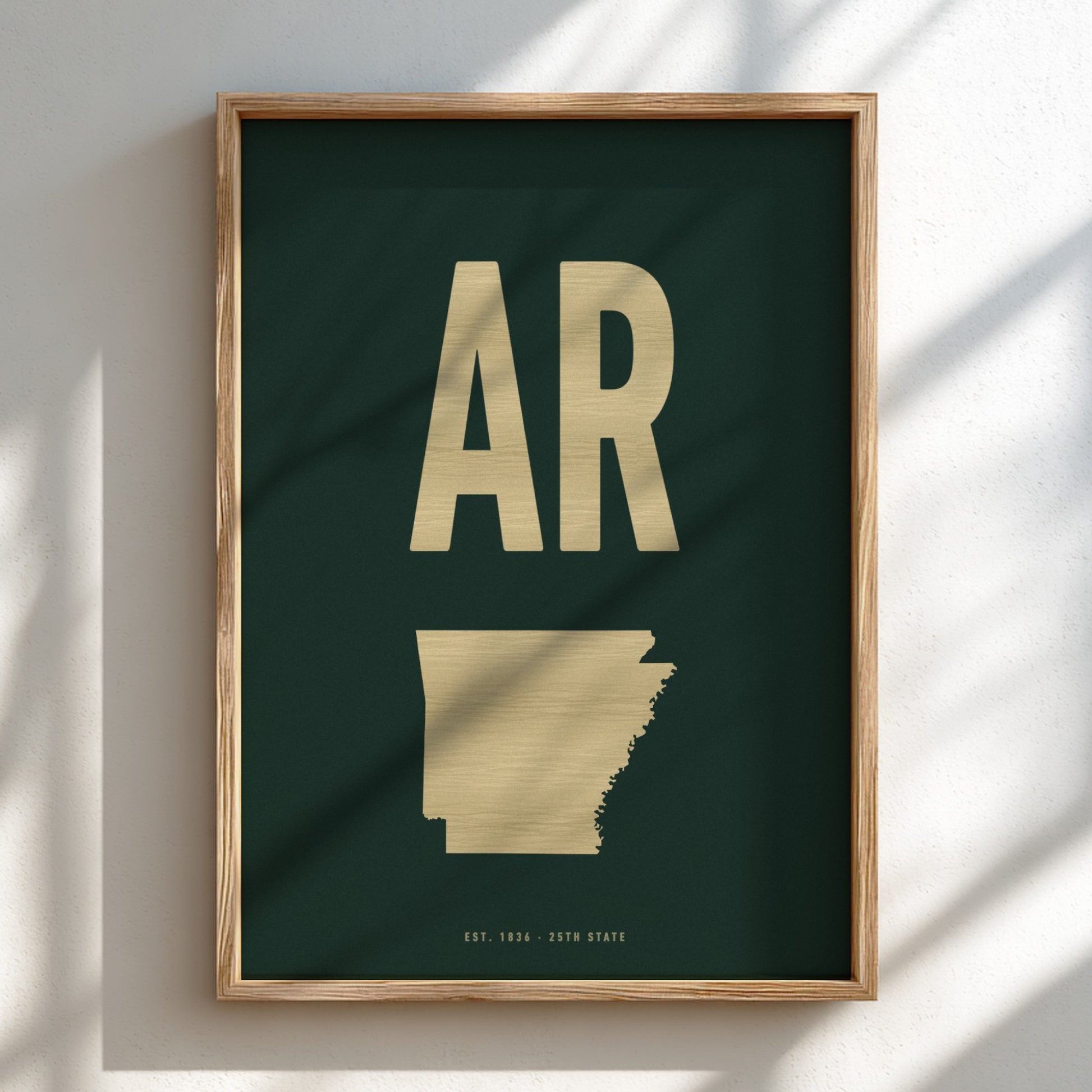 Framed artwork with 'AR' in gold on a dark green background
