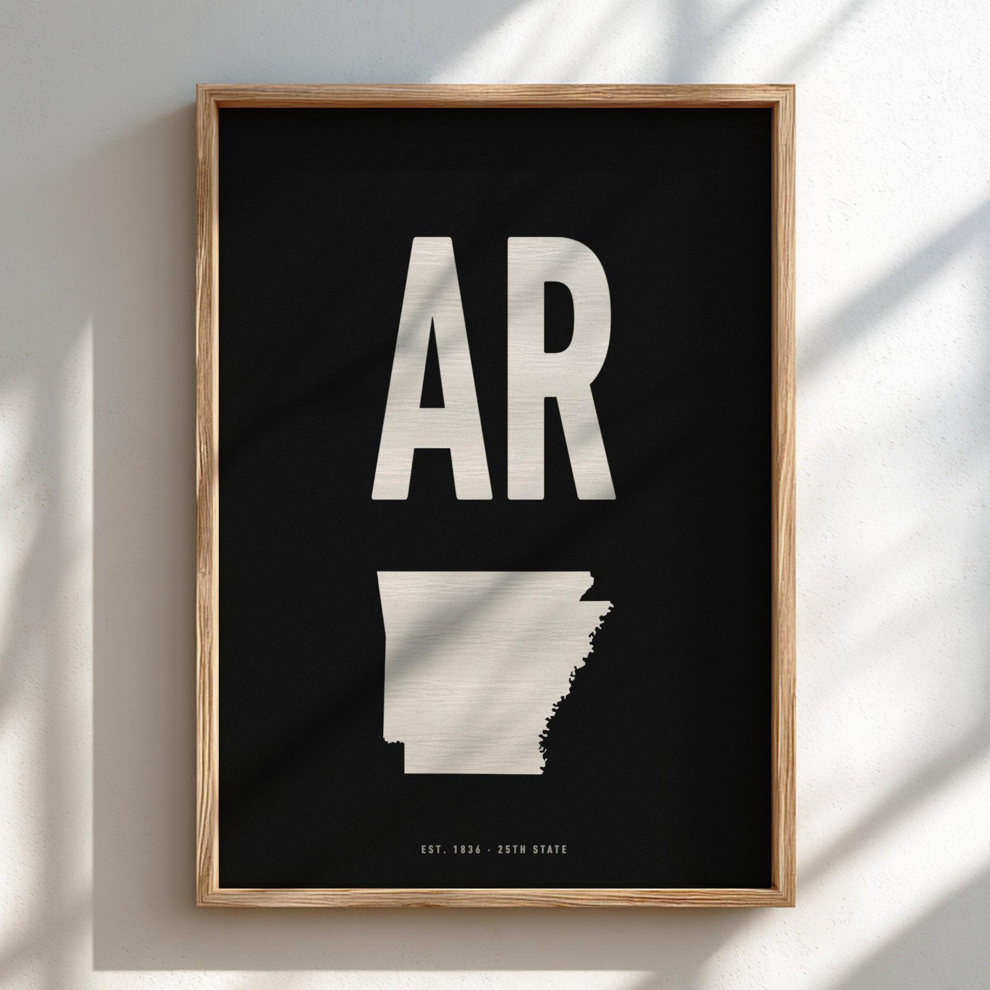 Framed poster with 'AR' and outline of Arkansas on a black background